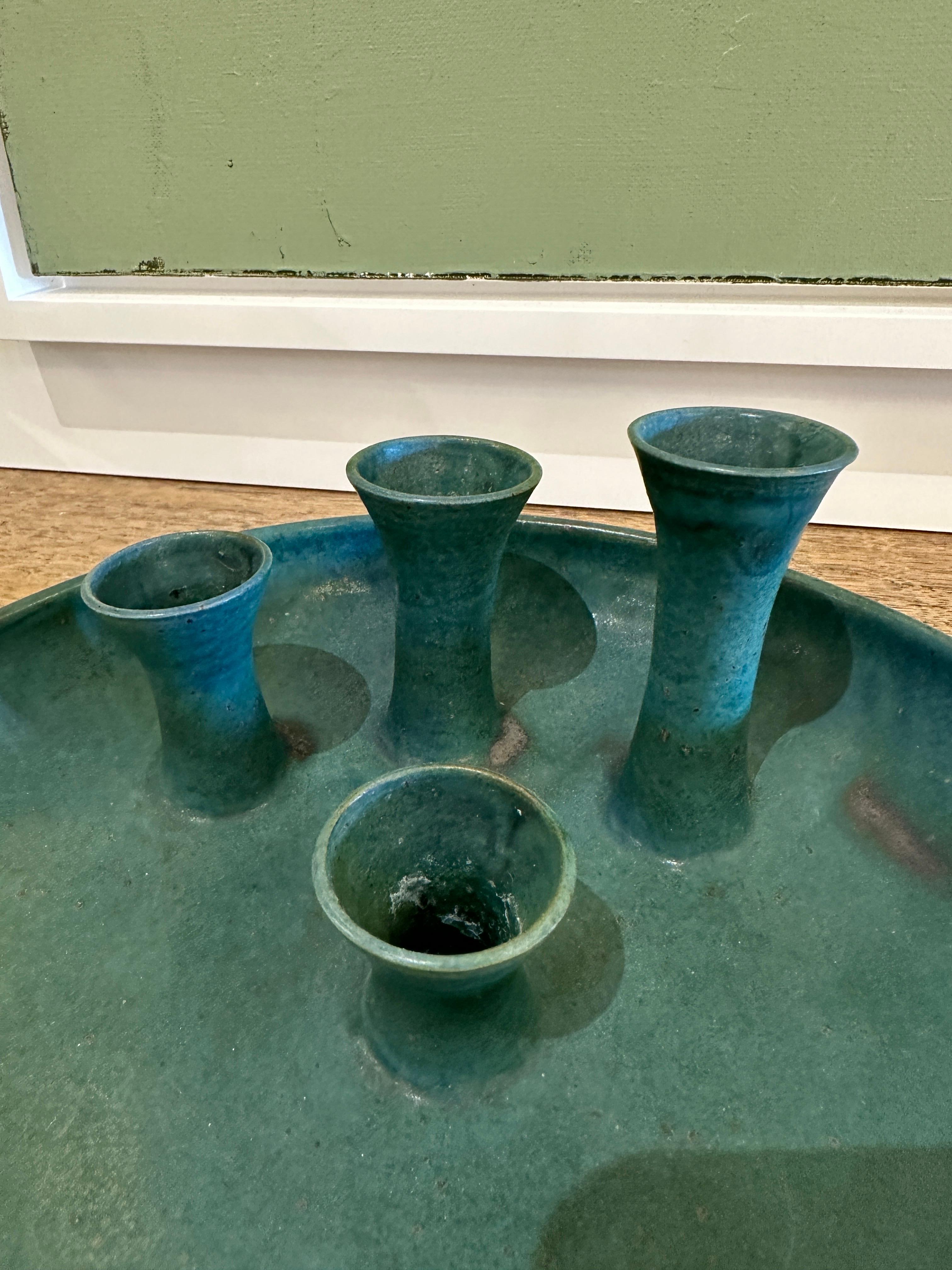 This lovely West German pottery bowl and bud vase features 4 varying sizes flower bud holders. The green matte finish has natural variations in coloring throughout. Wonderful vintage pottery from the West German school.  THIS ITEM IS LOCATED AND