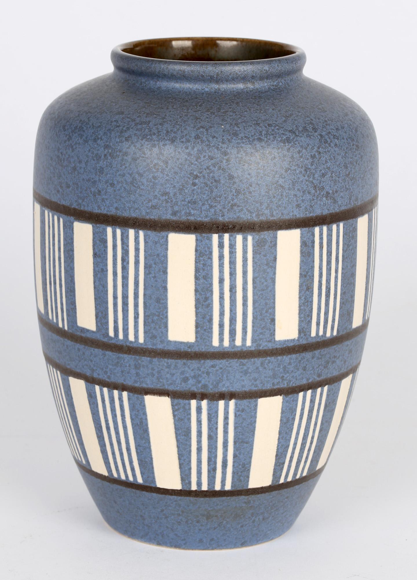 An exceptional quality West German mid-century art pottery vase decorated with a blue and white linear design possibly by Scheurich and dating around 1960. The finely potted vase is of rounded bulbous shape standing on a narrow rounded foot with a