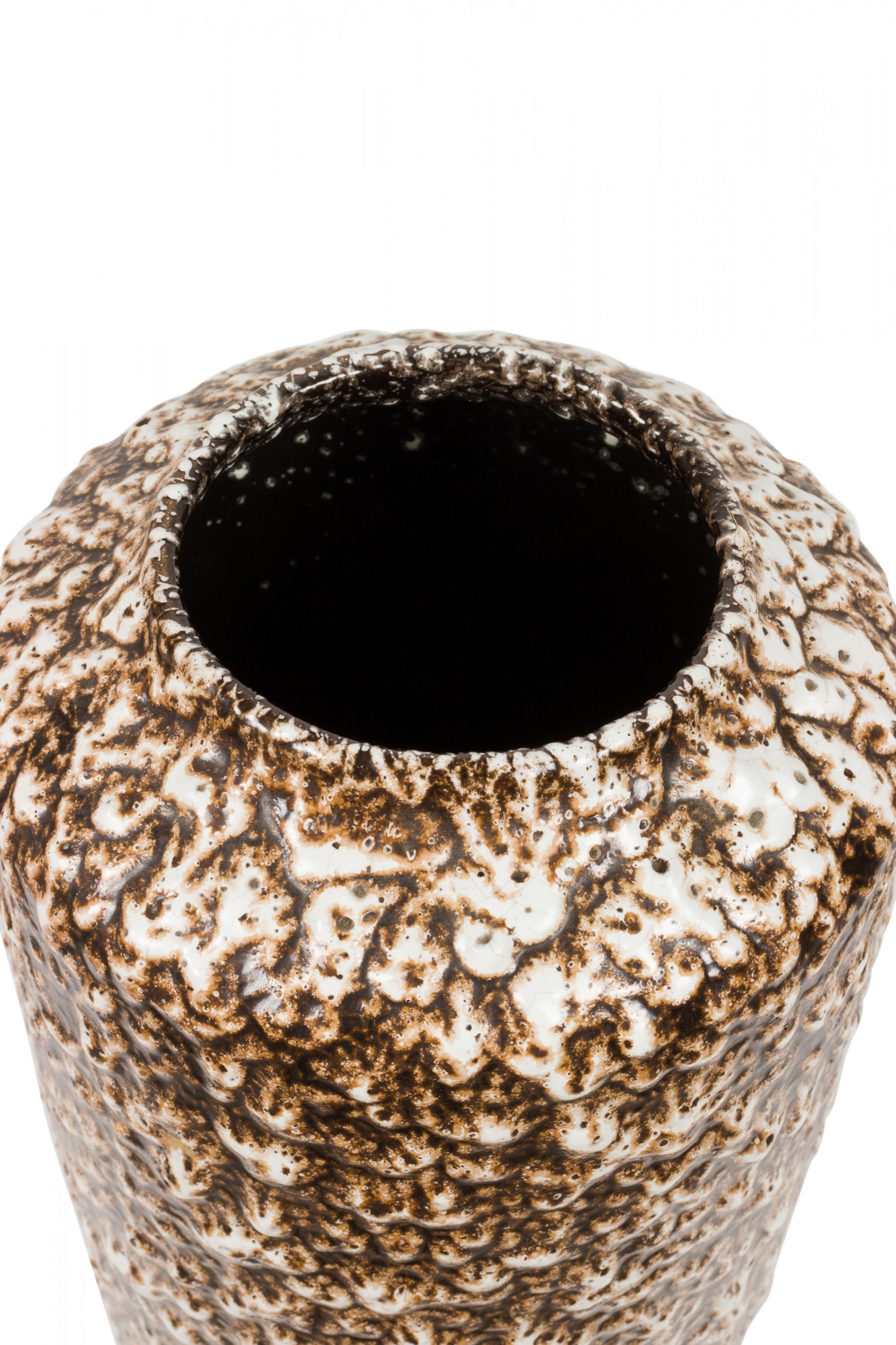 West German Mid-Century cylindrical-form ceramic vase with a pitted and bubbled fat lava glaze in beige and deep brown. (mark on bottom, W. GERMANY 517-38).