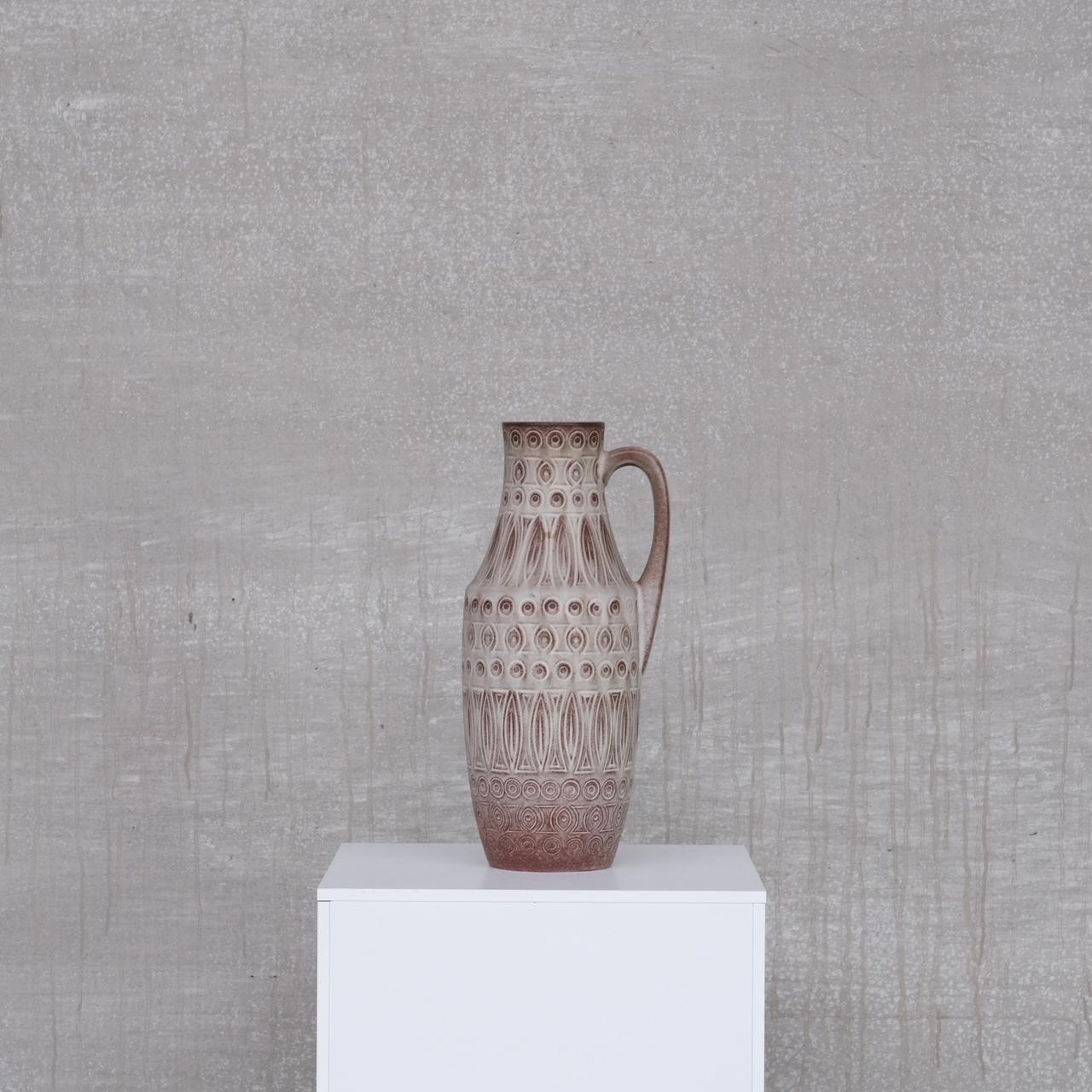 A mid to large sized ceramic vase. 

Stamped to the base. 

Mid to late 20th, Germany. 

Muted grey colour with hints of red coming through.

Location: Belgium Gallery. 

Dimensions:47 H x 23 W x 18 D in cm. 

Delivery: POA

We can