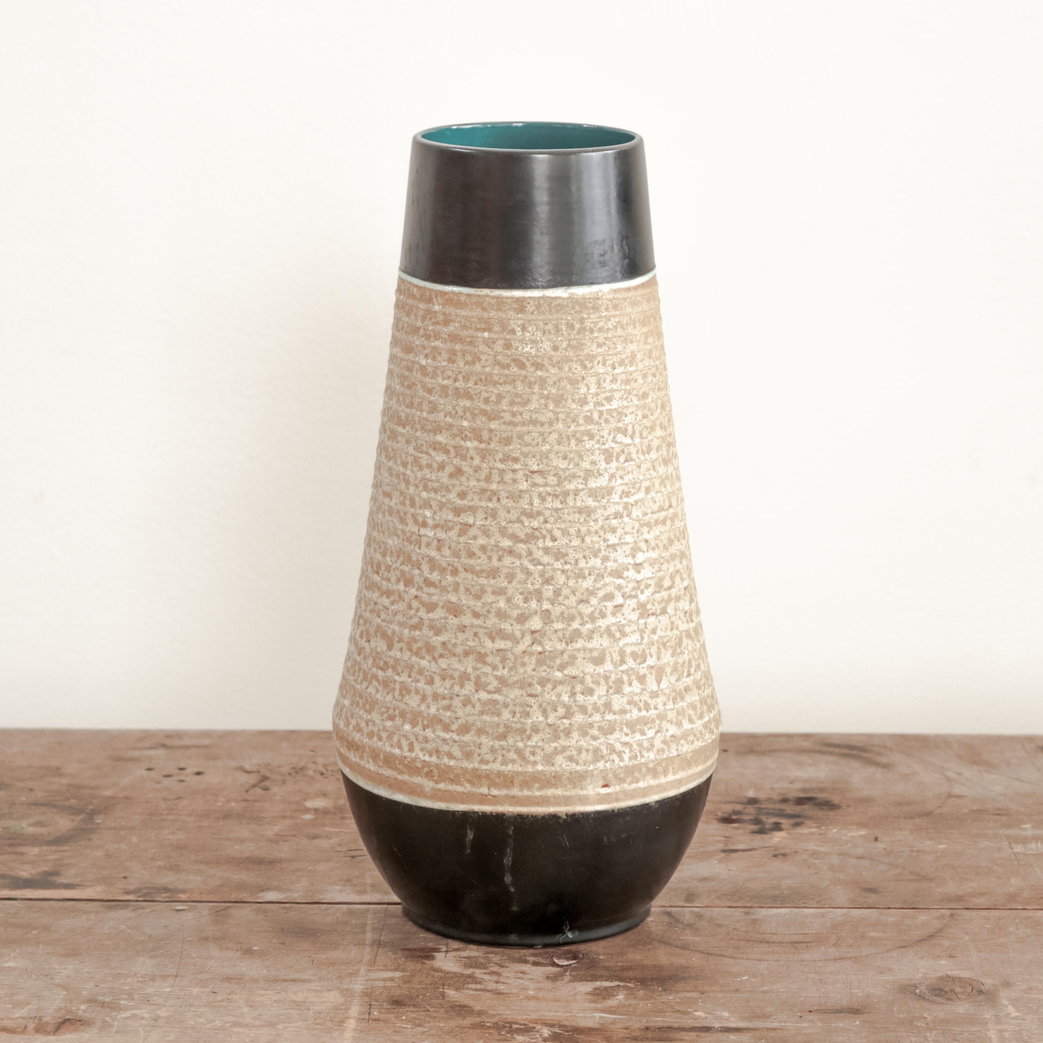 Ceramic vessel 12-32-38 with navy blue glazed ends and ribbed beige body, West Germany circa 1970's. 