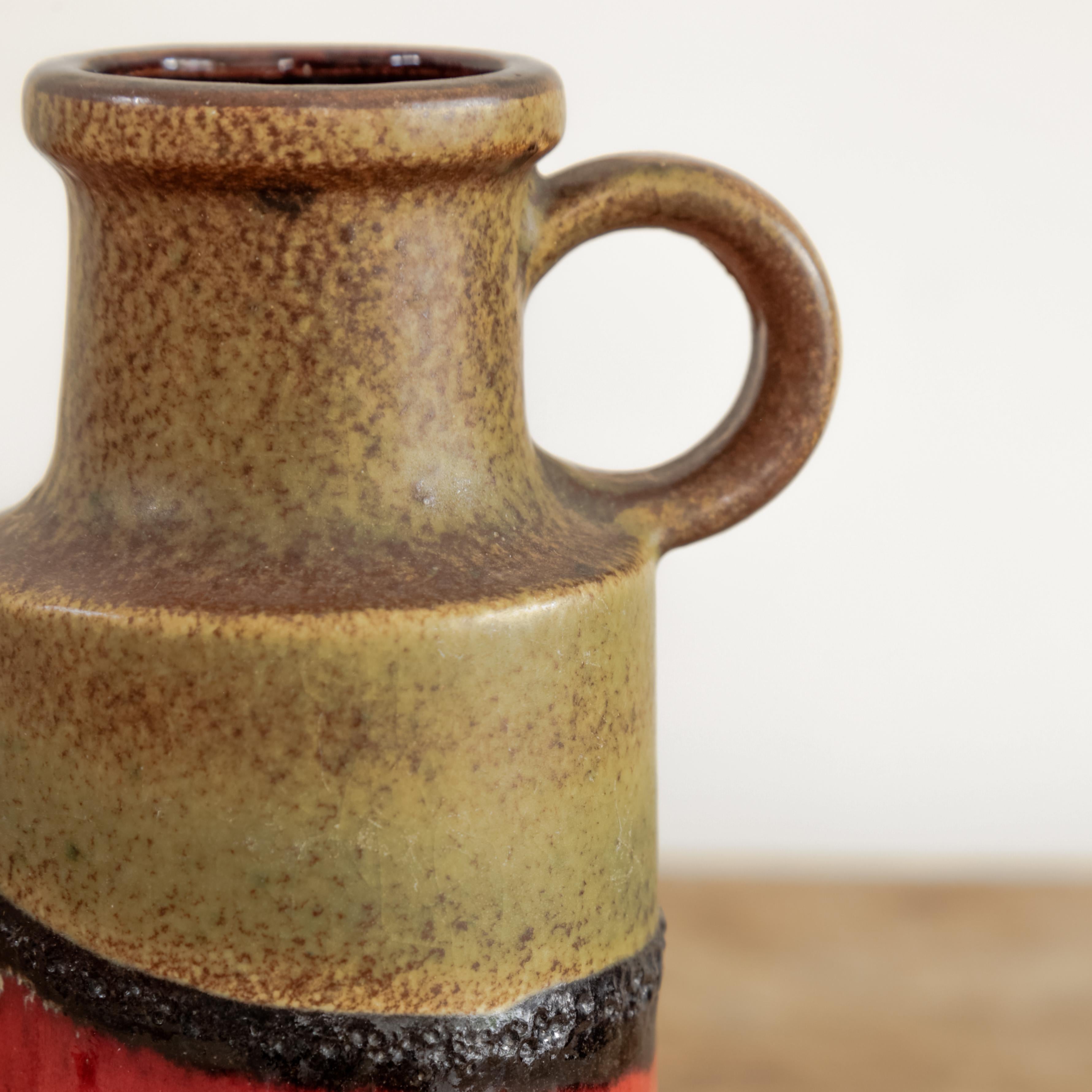 Earthy ceramic vessel 407-20 with textural brown and orange details and handle, West Germany circa 1970's. 
