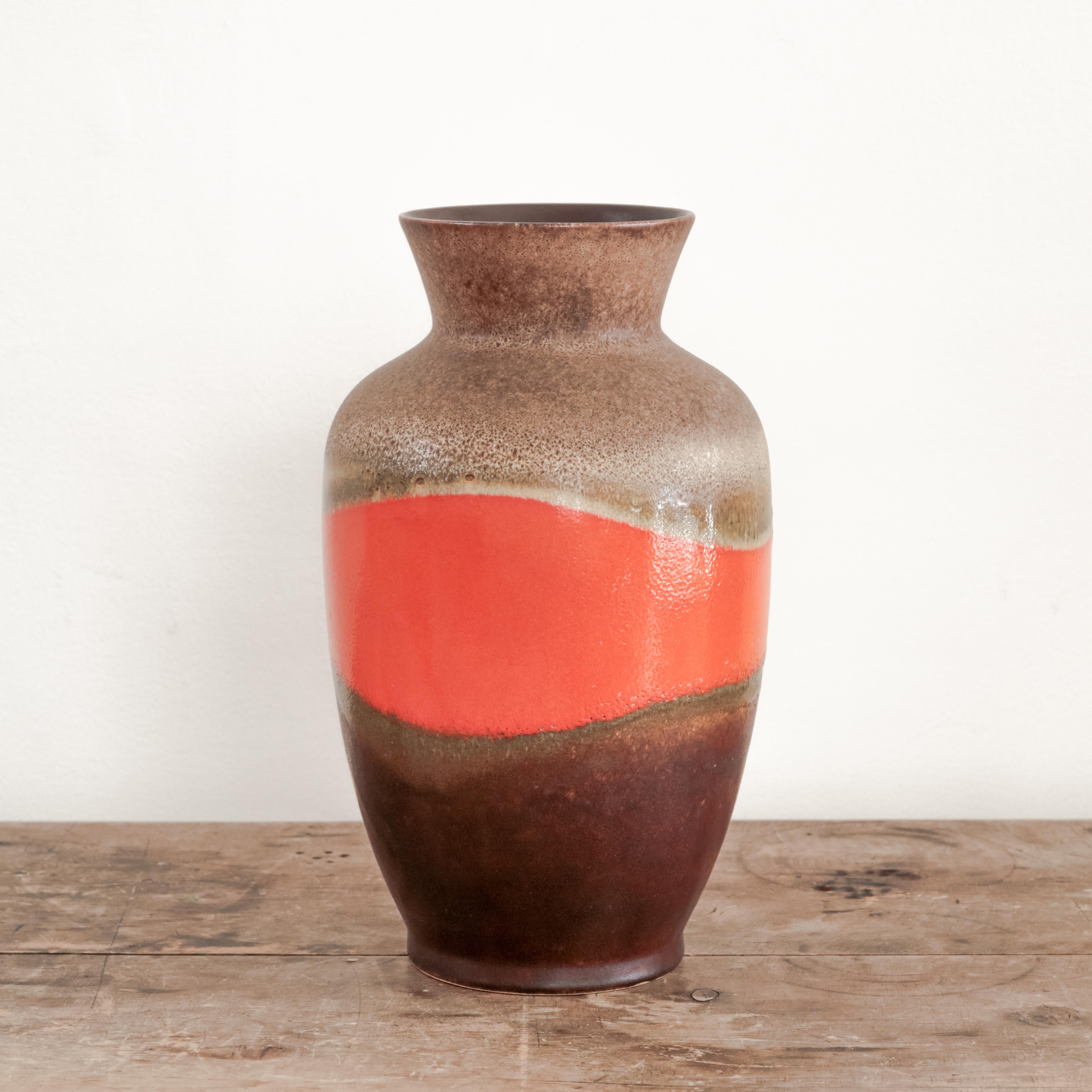 Ceramic vase with flared lip top and brown and orange glazing with banding detail, West Germany circa 1970's.