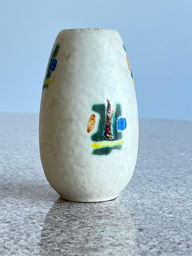 West German 1960s Glazed red and white ceramic vase.
Abstract art in green yellow blue red.
  