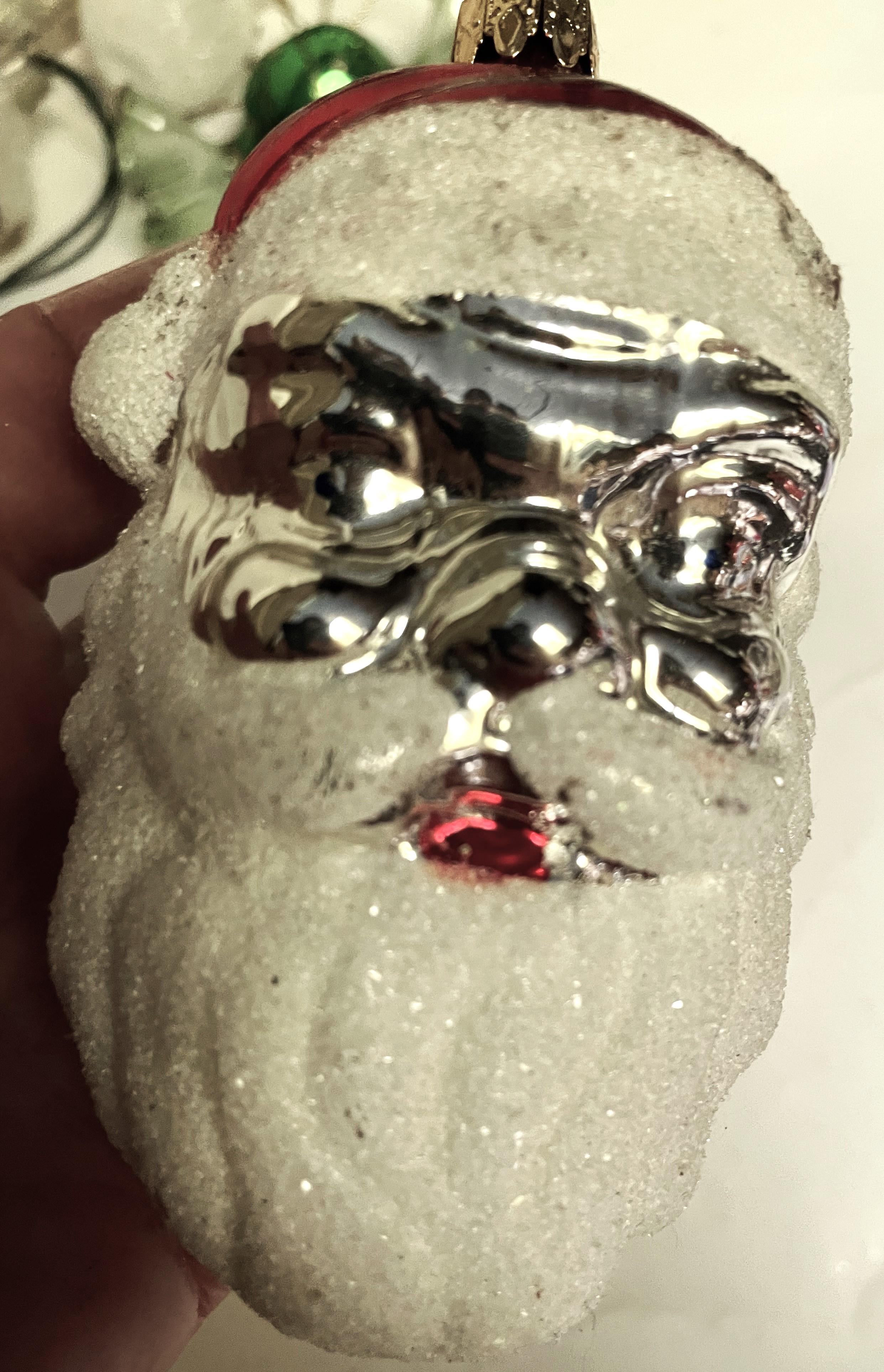 What a great large mercury glass Santa head Christmas tree ornament. The beard, mustache, hat band and pompom are all covered with a sugary snow looking finish but the back, face and hat are all shiny and bright. 

The ornament is in good condition