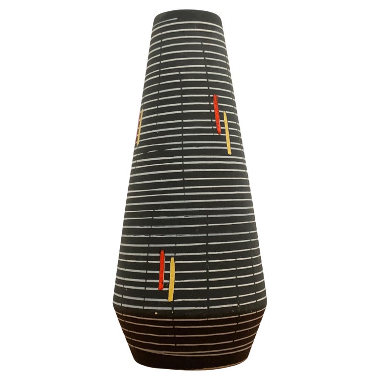 An abstract black and white lined ceramic vase with accents of yellow and red designed. West Germany, 1960s.