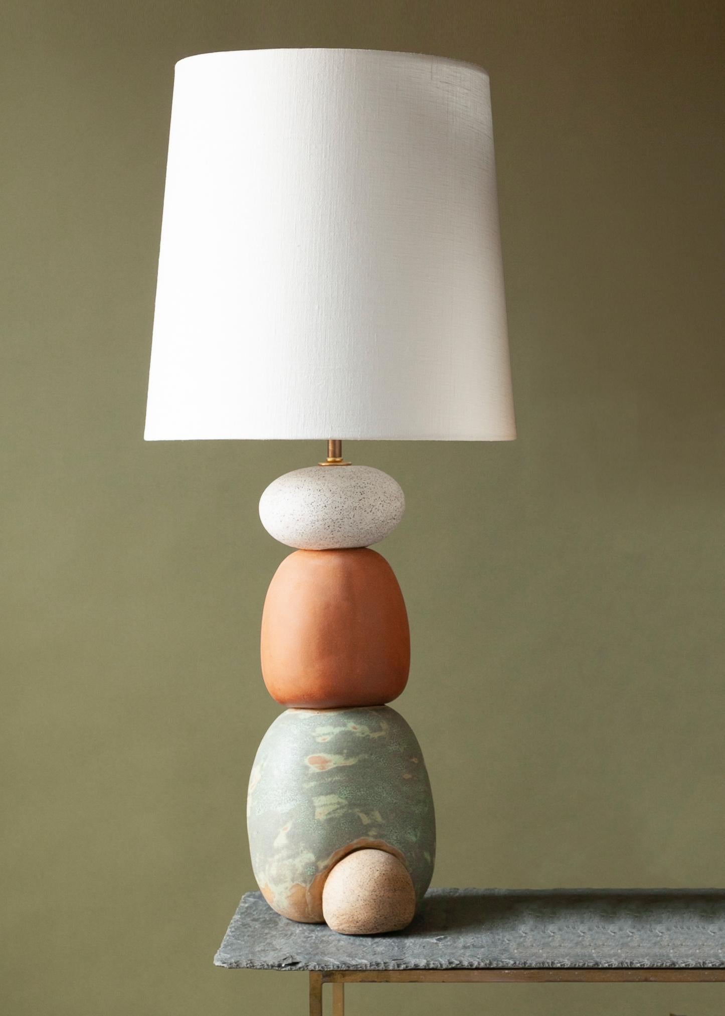 One of a kind ceramic lamp, thrown on the potters wheel and assembled by hand. This is a larger version of the original West lamp. The lamp base is comprised of two different clay bodies and features a coppery green handmade glaze in contrast to a