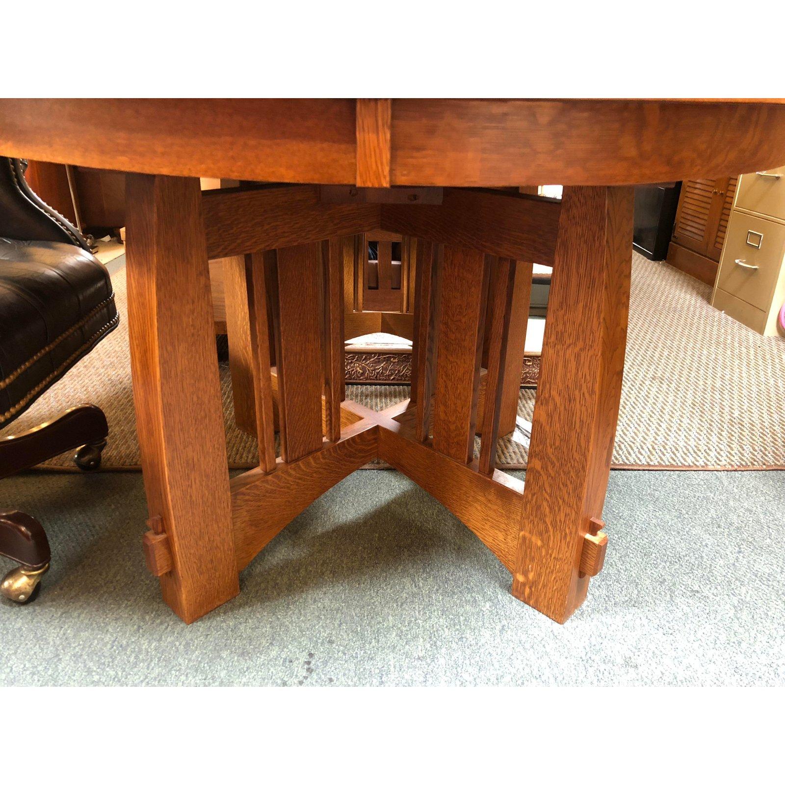 A Brookville Pub Table by West Point. Straight from a designer showroom. A handcrafted X shaped base design with a round top surface. The wood is a quarter sawn white oak. Comes with two extension leafs. Hand crafted in U.S.A. 
Extension