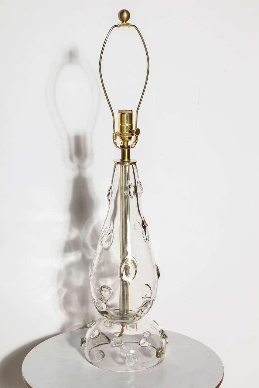 American Mid Century hand blown clear Art Glass Table Lamp with glass button decoration. Featuring a large, handcrafted refracting and transparent teardrop form with three dimensional glass button appliqués flowing onto the rounded dome reflective