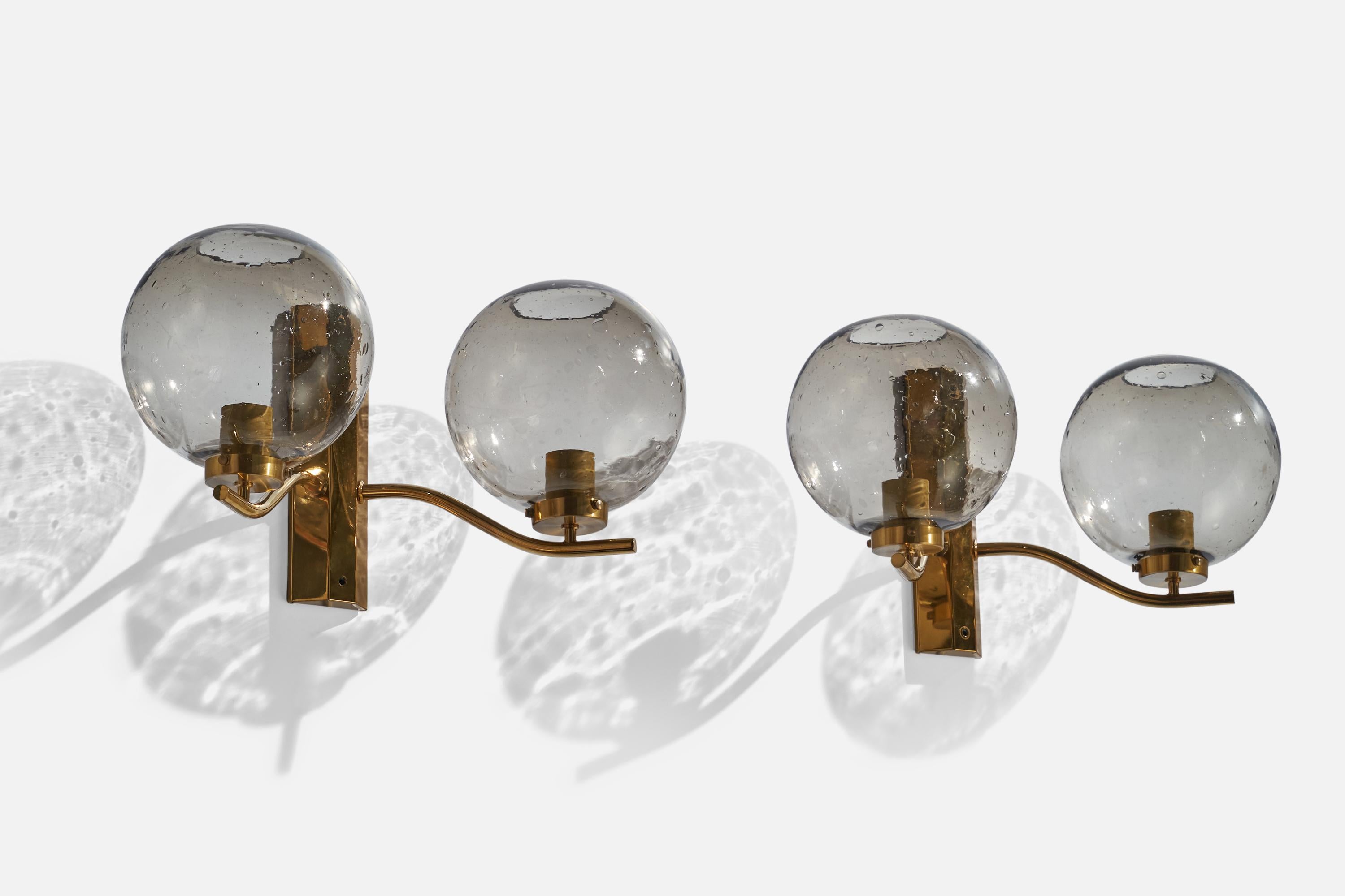A pair of brass and smoked glass wall lights designed and produced by Westal Bankeryd, Sweden, 1970s.

Overall Dimensions (inches): 10” H x 19” W x 9.75” D
Back Plate Dimensions (inches): 10”  H x 2.75” W x 1.1” D
Bulb Specifications: E-26