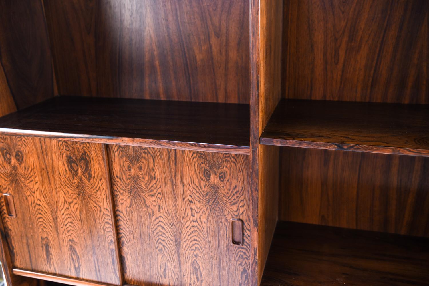 This Danish midcentury rosewood bookcase by Westergaard Møbelfabrik Silkeborg is the perfect storage or display cabinet. With multiple hidden and revealed compartments, this piece provides ample room for organized storage and display.