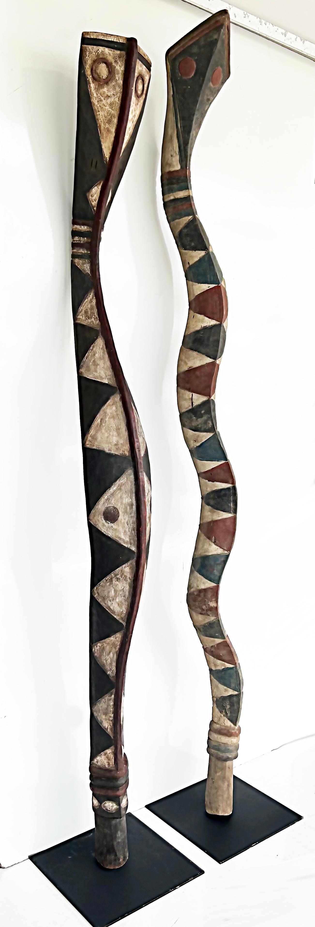 Western African, Guinea or Senegal Baga serpent sculptures on Custom Iron Stands

Offered for sale is a pair of outstanding Western African (Guinea) Baga society carved and painted wood serpent sculptures which symbolize protection. These