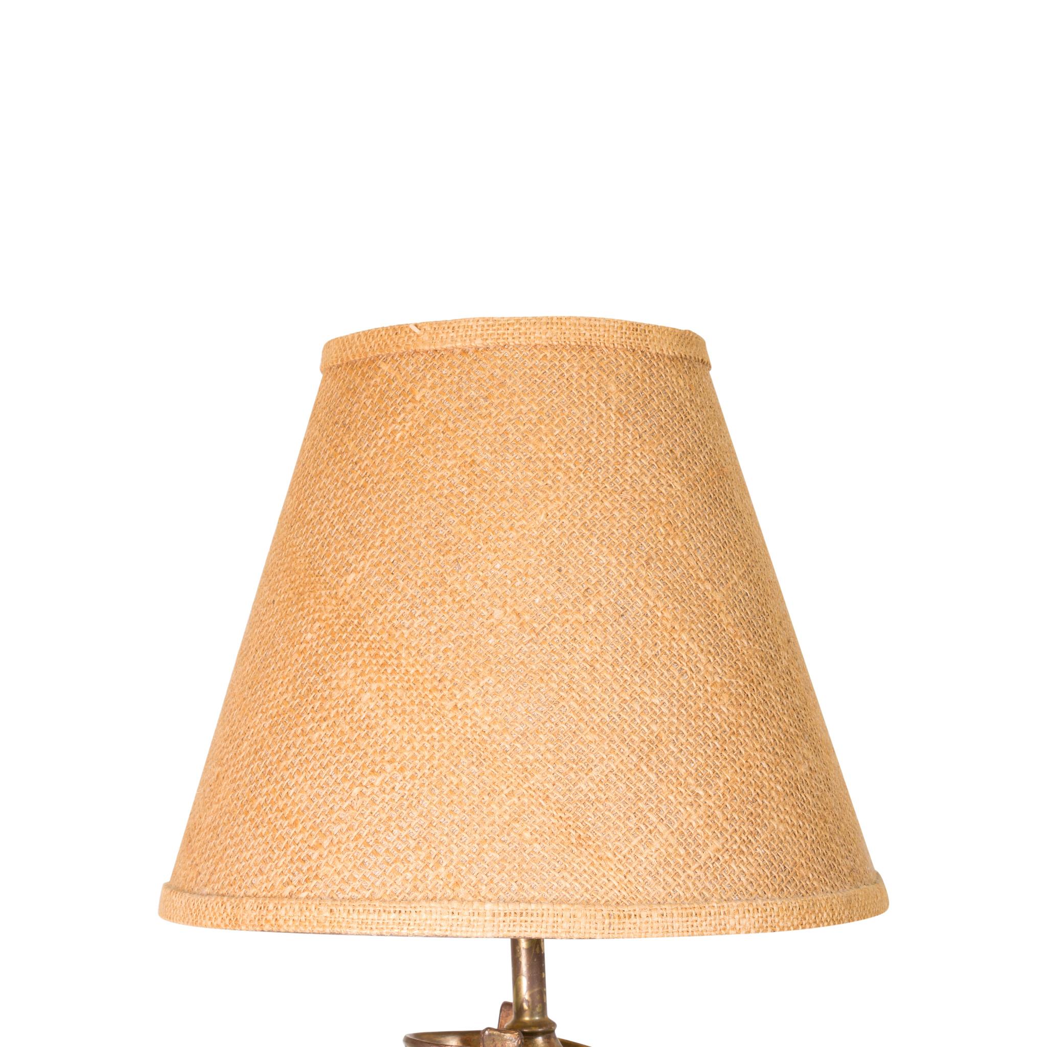 Bronze boot lamp with original burlap shade.

Period: circa 1940.

Origin: United States

Size: Shade 12