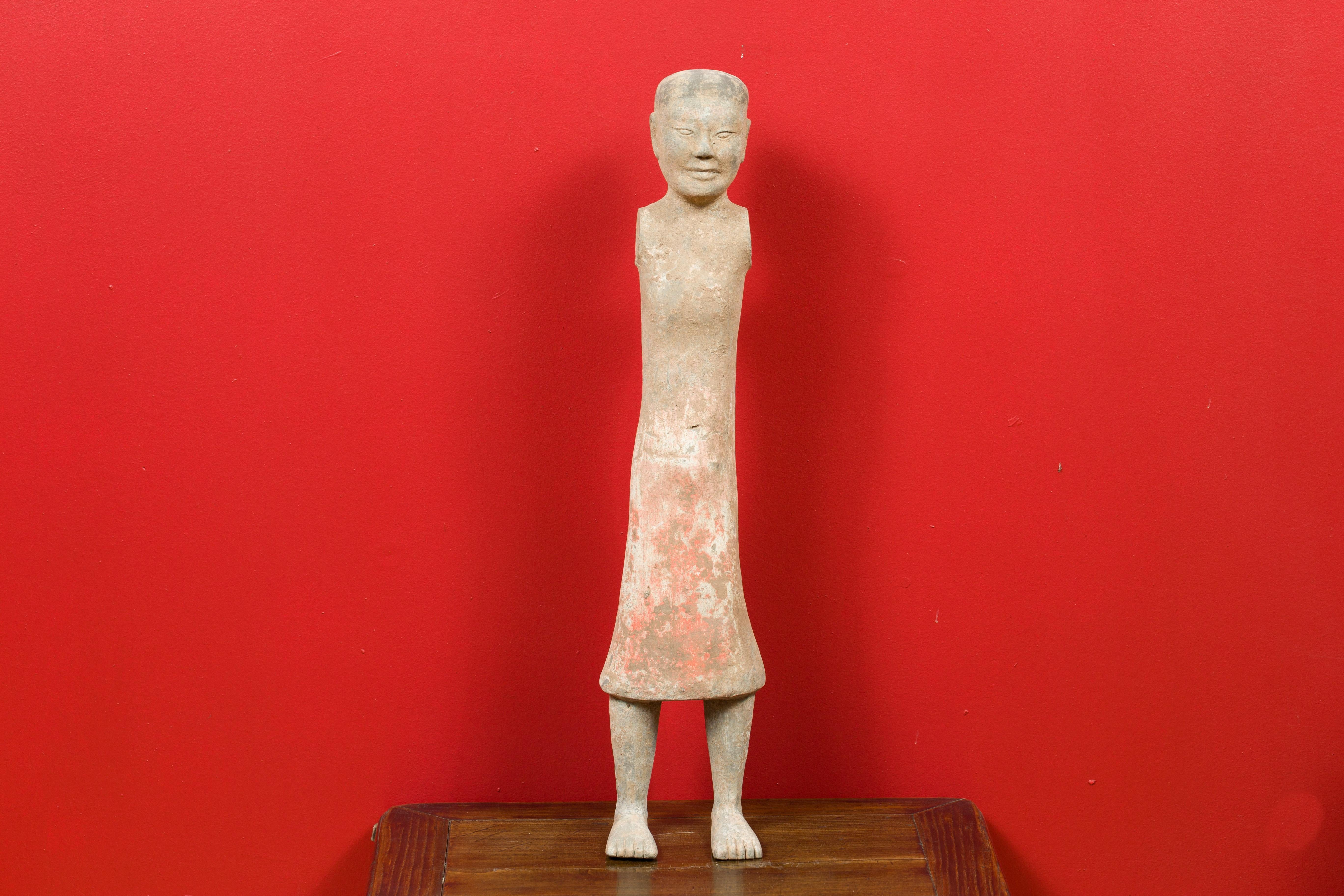 A Chinese Western Han dynasty period armless figurine with original polychromy. Born in China during the Western Han dynasty (206 BC-24 AD), this half-naked and armless figurine features a polished surface showing its original polychrome. These