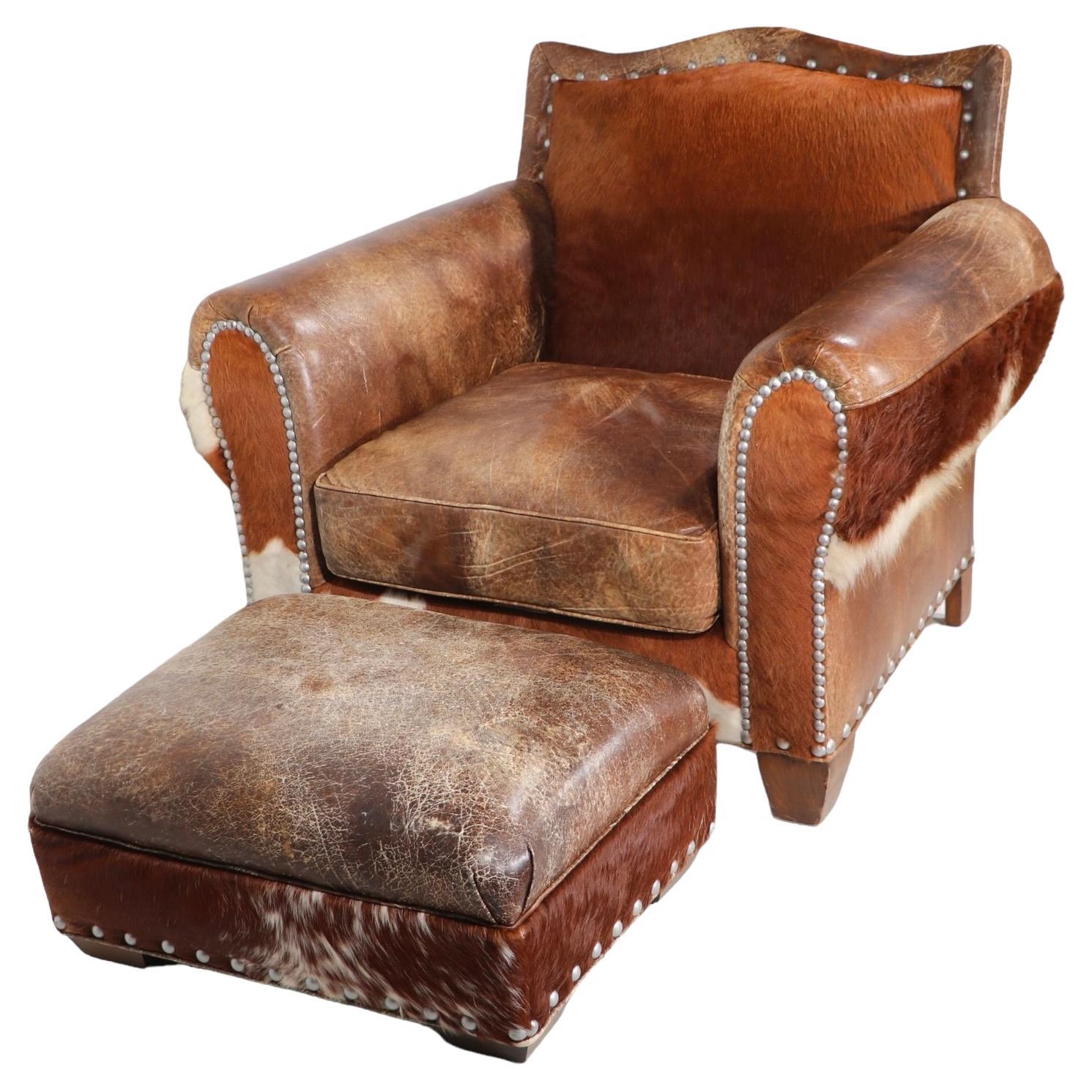 Exceptional Western style leather and  cow hide lounge chair and ottoman by noted American furniture company, Old Hickory Tannery. These pieces are in excellent, original, clean and ready to use condition, free of damage or repairs. 
 Chair