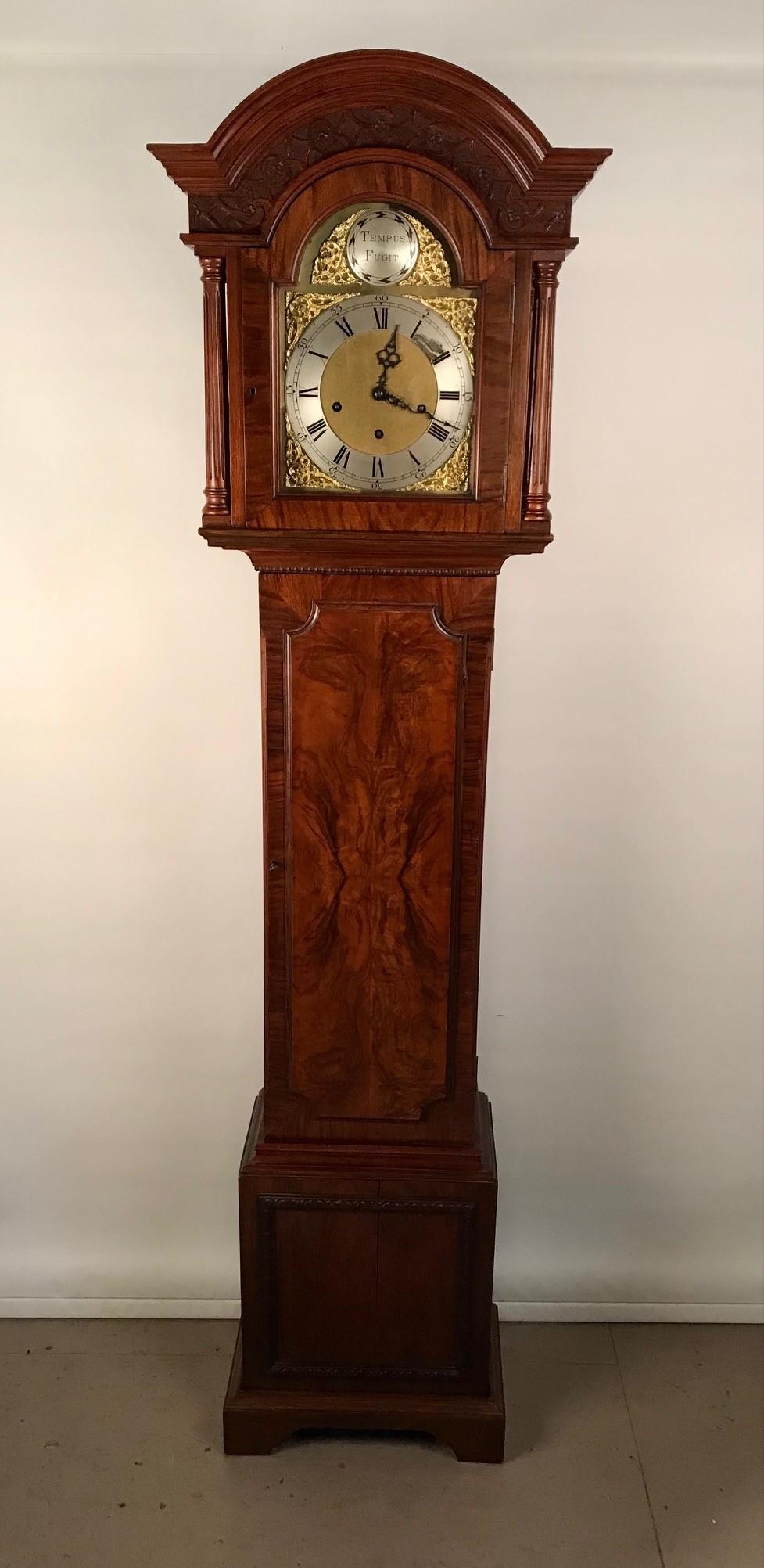 This grandmother clock has a spring-driven, three train, chiming movement, facilitating the Westminster chime on a nest of gong rods. The case is made of solid mahogany and is made in the Georgian London style as is the norm for early 20th century