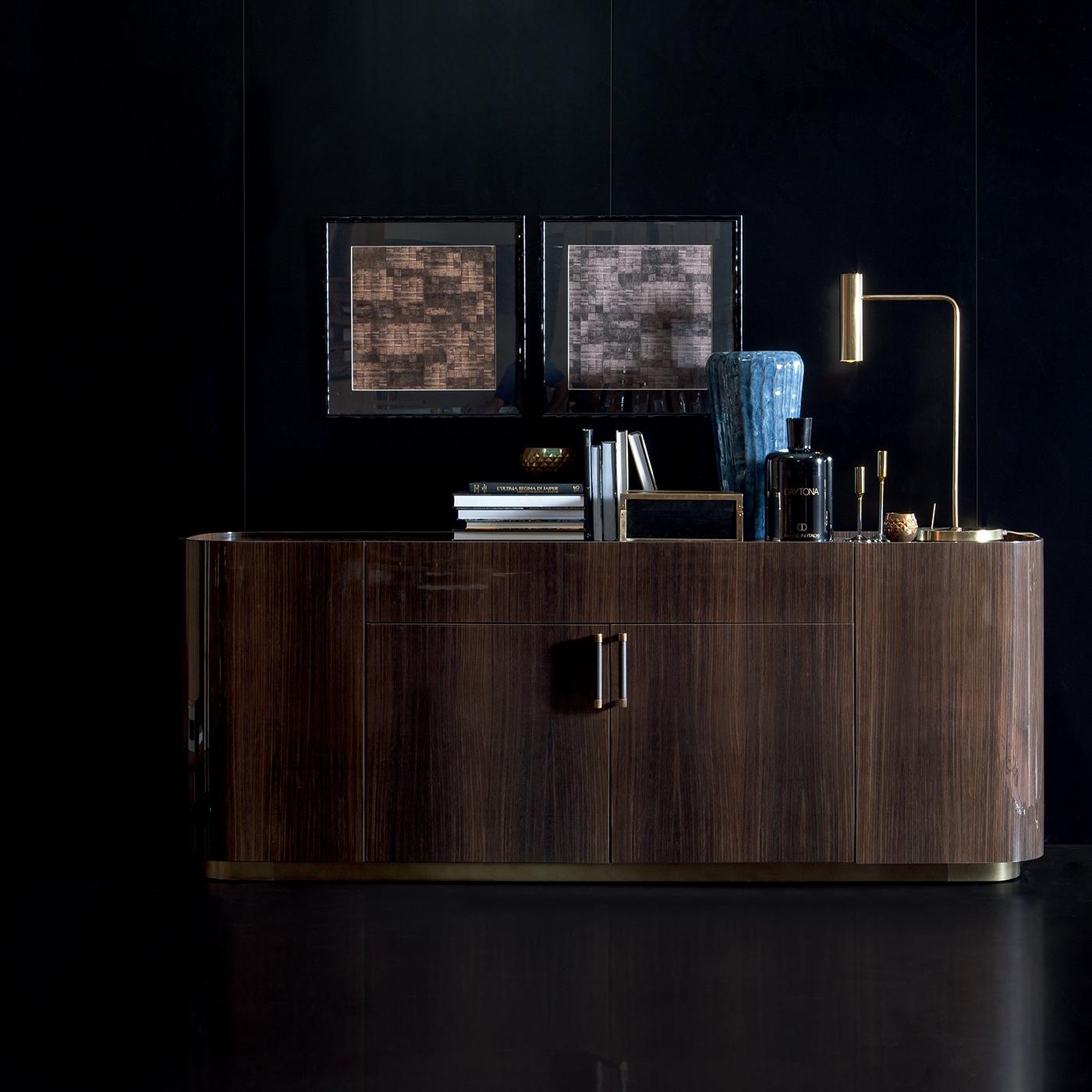 This masterfully executed sideboard reinterprets the concept of traditional storage unit into a timeless design that will make every environment a one-of-a-kind and functional place. Entirely made of curved plywood with a dark walnut veneer in
