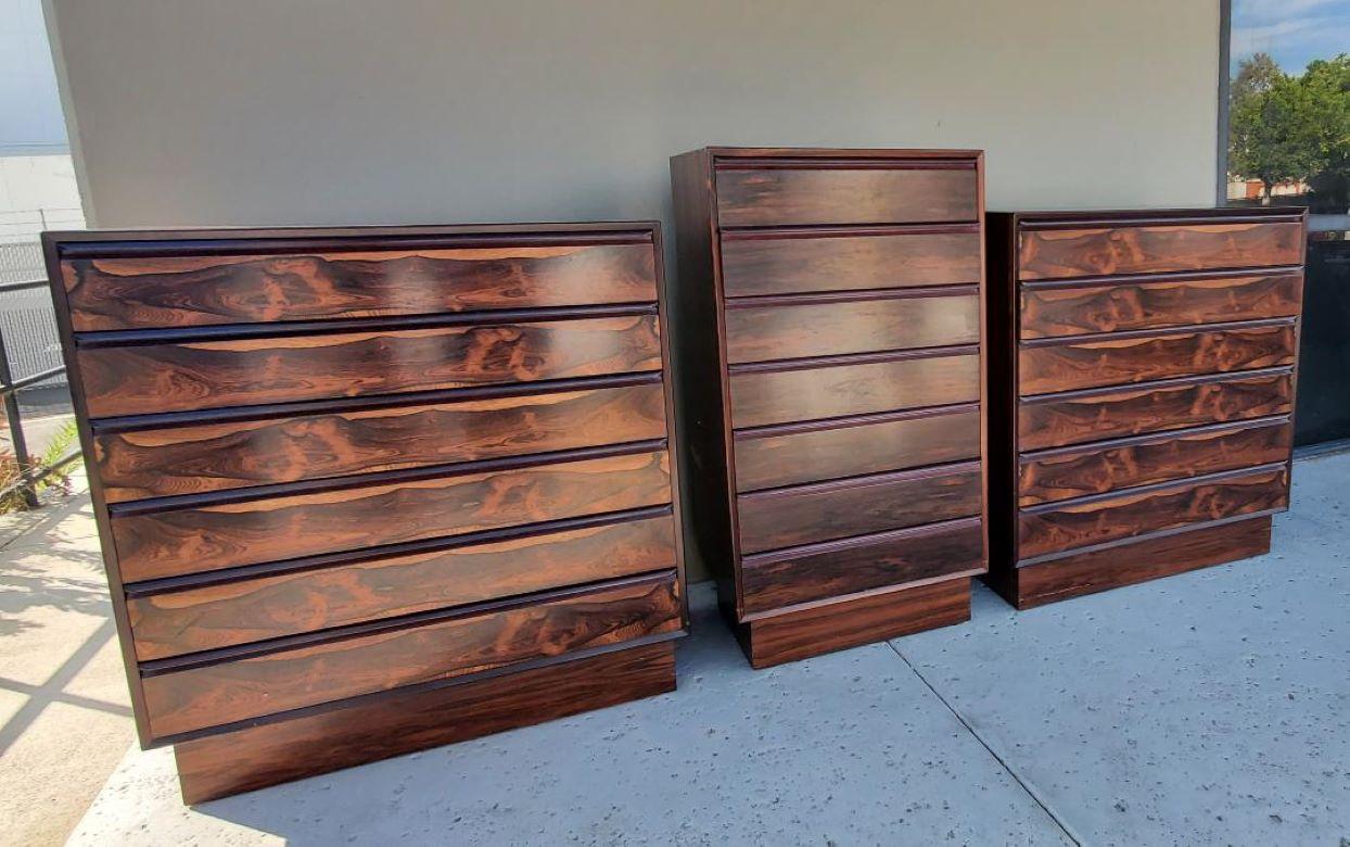 Westnofa of Norway labeled 3 Piece rosewood dresser Set, 1960s. Gorgeous Rosewood all the way around. These pieces are able to float within the room. There are 2 matching chest of drawers with a tall boy dresser. Each piece has 6 pull out drawers.