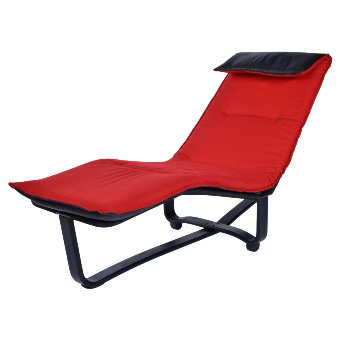 Westnofa Norwegian made leather chaise lounge with reversible cushion. This chaise is exemplary of Scandinavian design genius. It achieves so much, by such simple means. The original cushion is black leather on one side, and red wool on the other