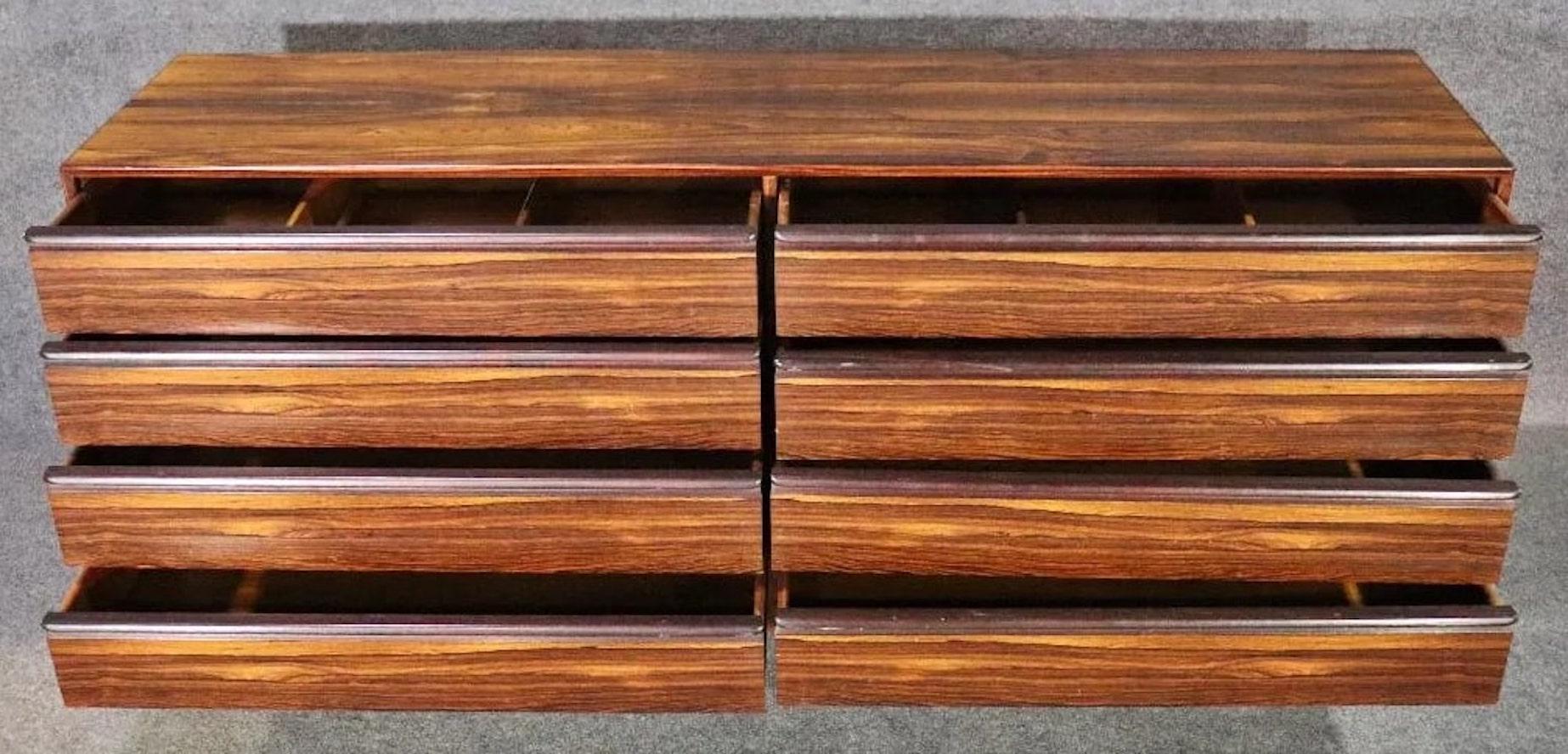 Long chest of drawers in rich rosewood grain. Made by Westnofa in Norway, with finished back and long sculpted handles.
Please confirm location NY or NJ.