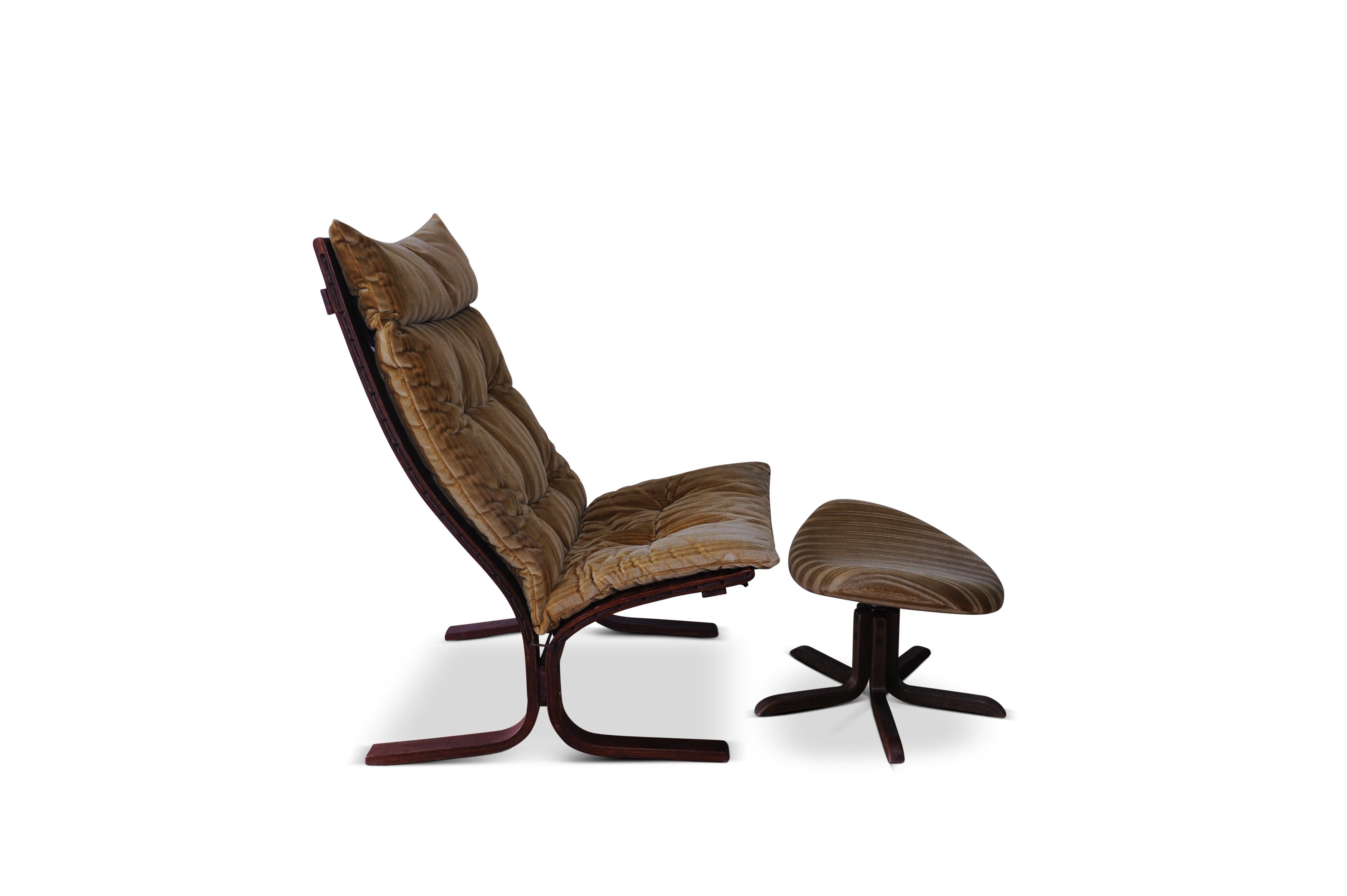 Westnofa Siesta bentwood lounge chair with matching footstool
designed by Ingmar Relling 

This easy chair was designed by Ingmar Relling for Westnofa, Norway, circa 1965. It features a reddish brown stained bentwood frame and golden velvet