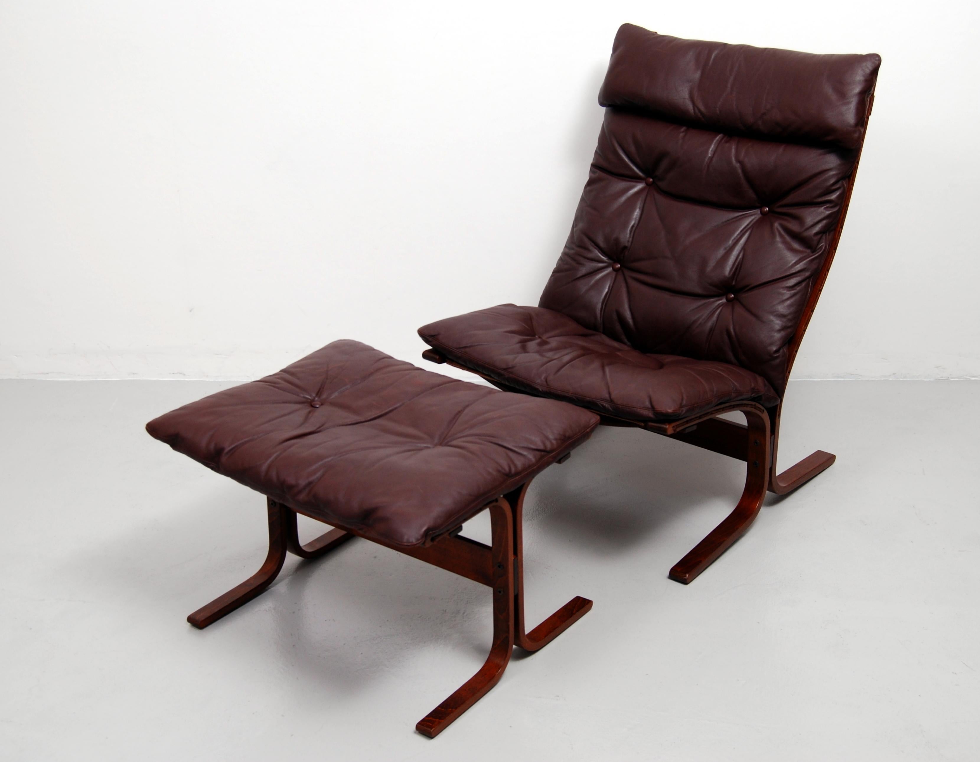 Siesta high back lounge chair and matching ottoman designed by Ingmar Relling and made in Norway by Westnofa. This award winning chair and ottoman has a bentwood frame with a leather cushion that sits on a canvas sling. Labelled with Westnofa