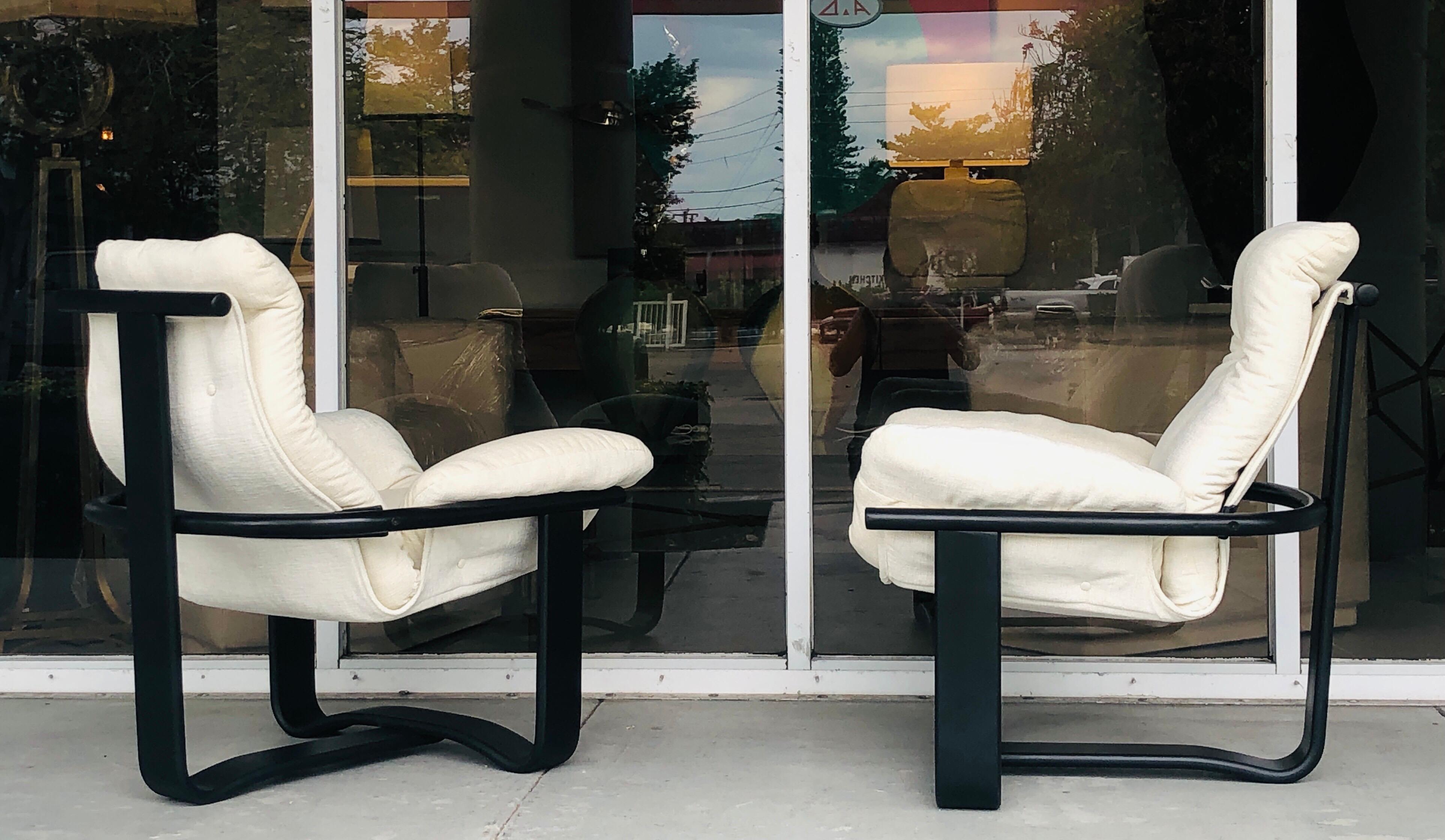 A great pair of chairs. Black enameled wood frame, from which the seats hang free. Beautiful modern design, clever and comfortable at once.