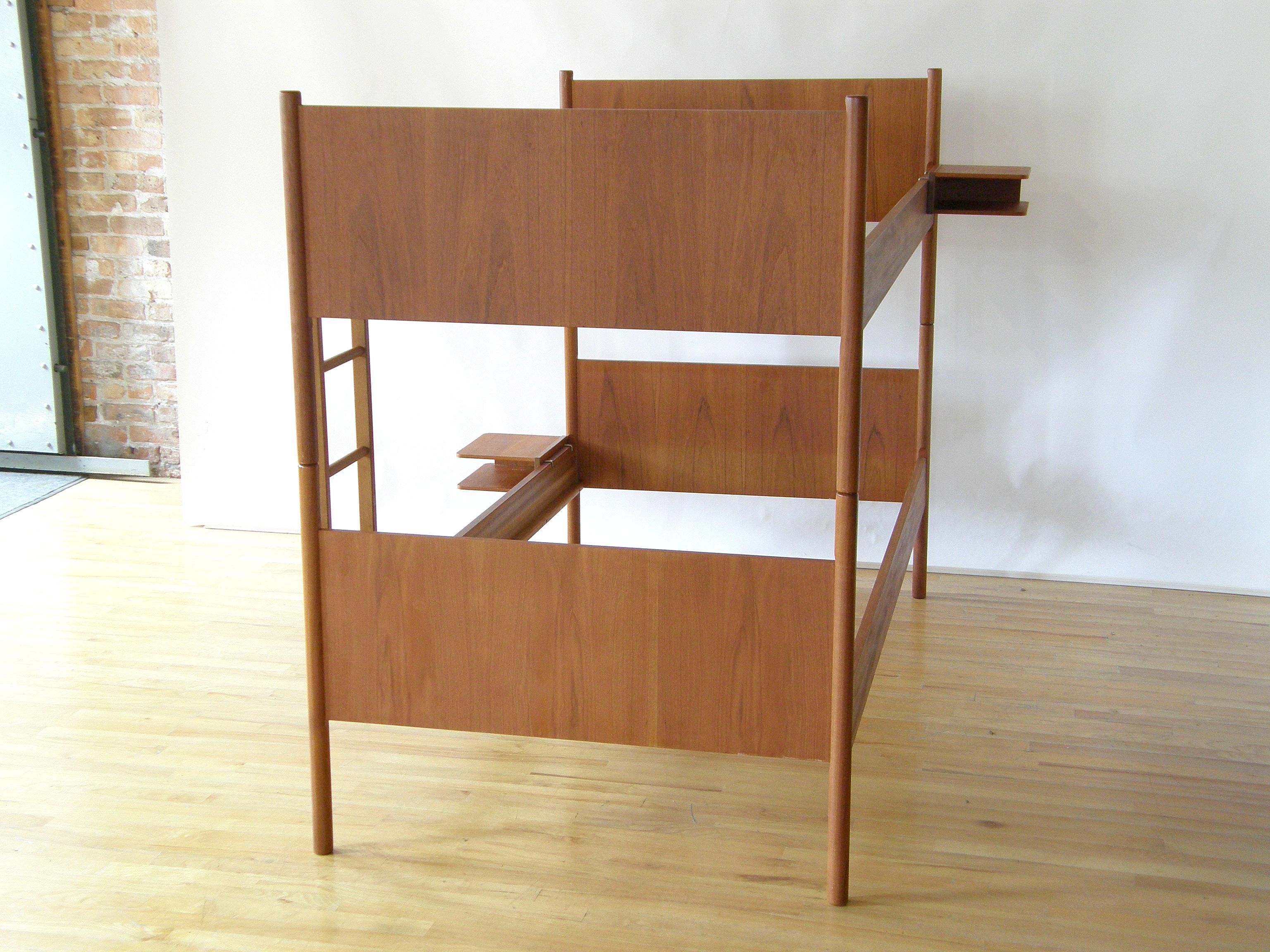 These teak bunk beds were made in Norway by the Westnofa furniture company. They have clean lines and smartly designed details. The two twin beds sit one on top of the other, and the legs are connected and held in place with metal rods. A guardrail