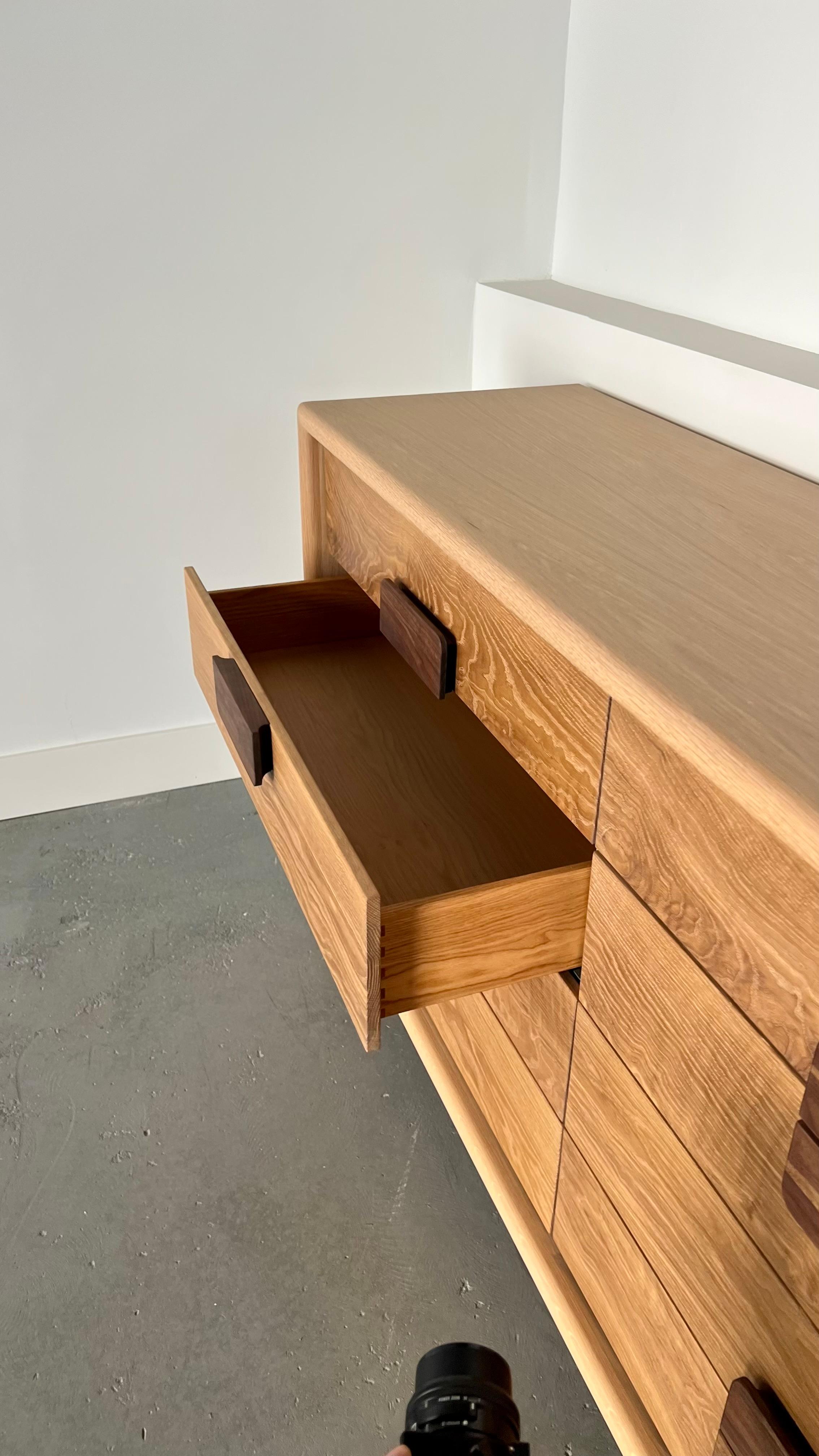 Part of the Canyon Collection collab with Natalie Myers.

A larger storage option in line with the Westridge Nightstand. 1.5” solid round over front faced veneer panels offers structural support for the solid hardwood drawer fronts and walnut