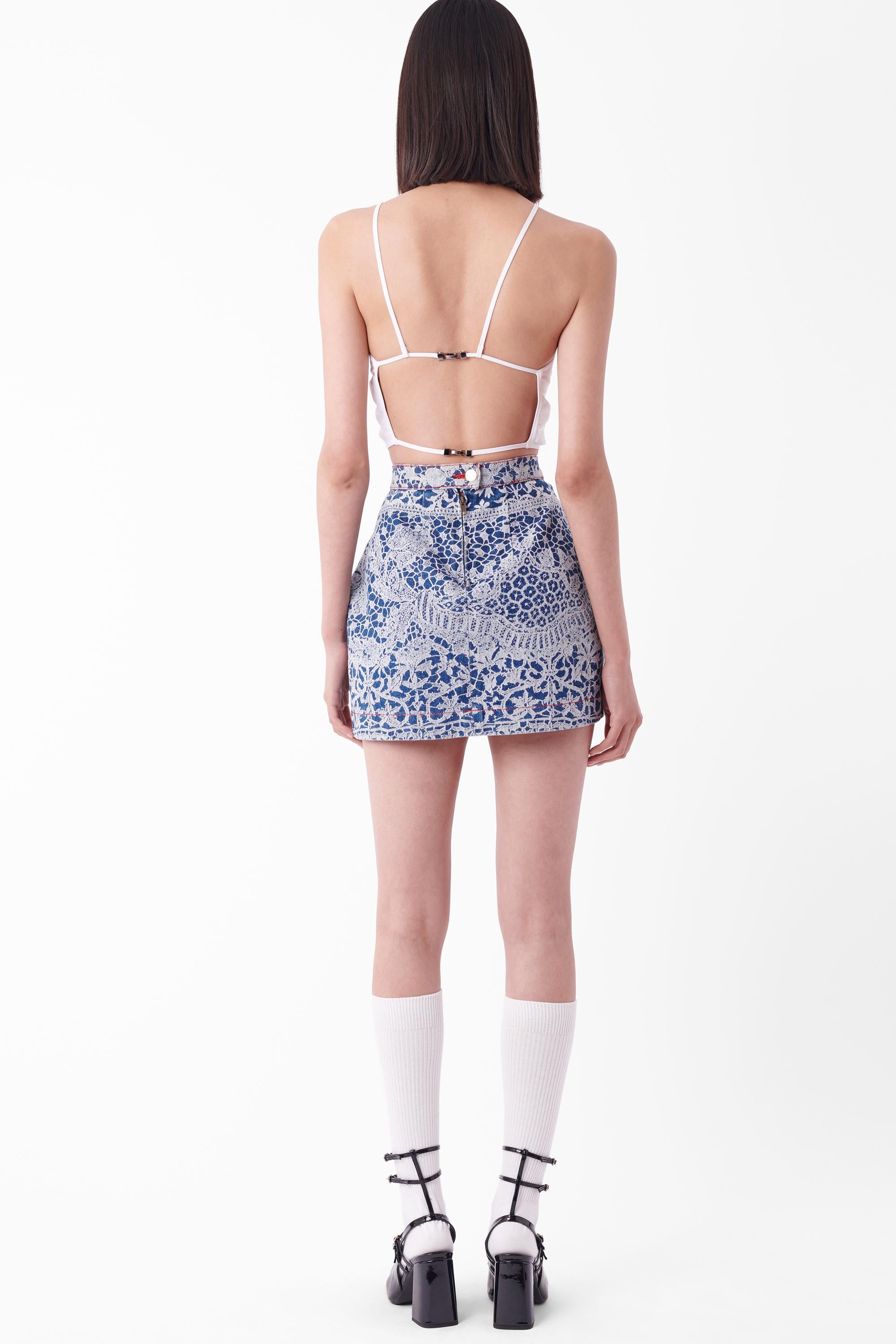 Vintage Vivienne Westwood Fall Winter 1992 denim mini skirt, from the ‘Always On Camera’ collection. Features iconic lace print, waistline pleating and darting to create an a-line fit, red contrast stitching and double front pockets with zip and