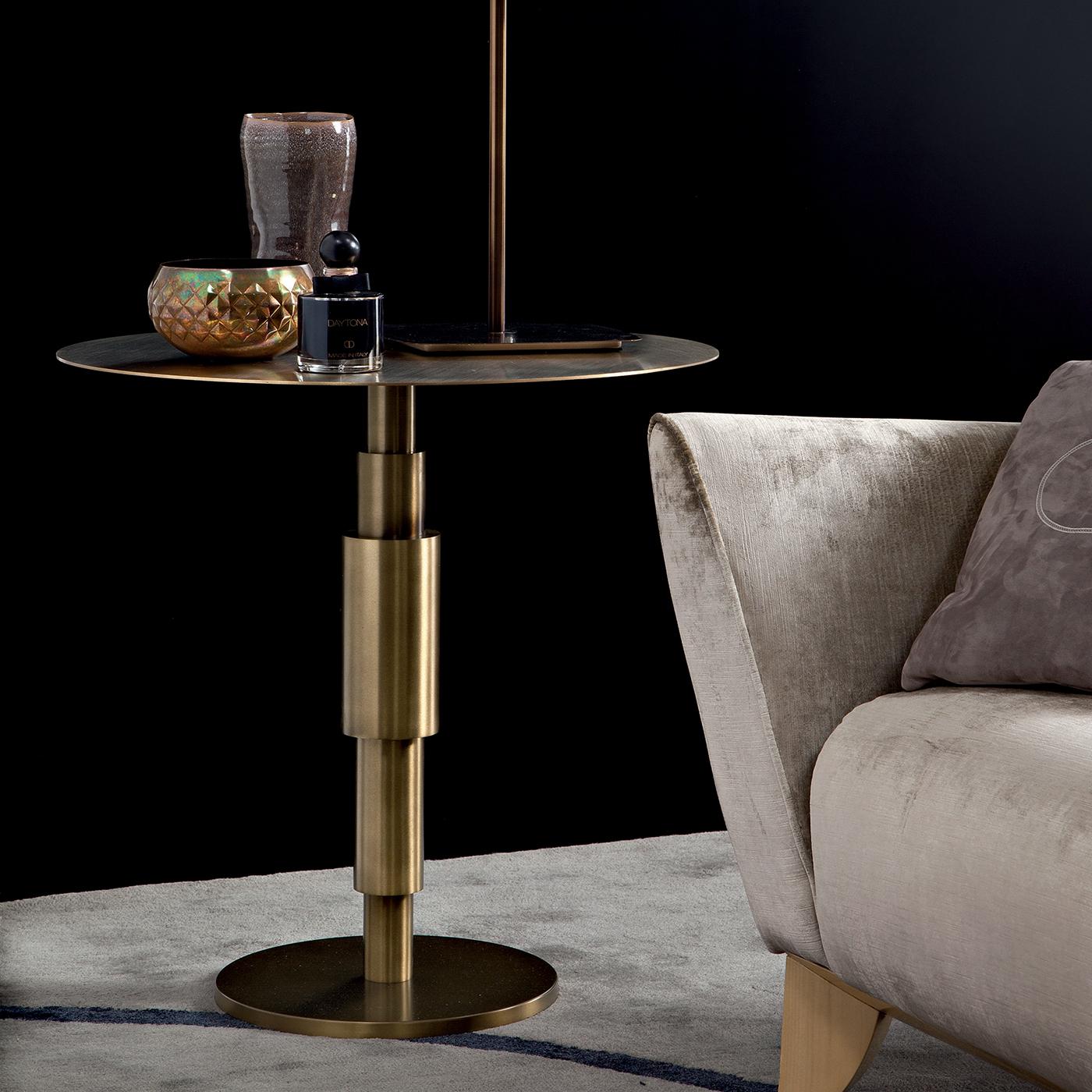 Alone or in a group, this striking side table will make the most lustrous statement in a contemporary living room, particularly with monochromatic furnishing. The small circular base and the unique concentric tubular pedestal form the structure in