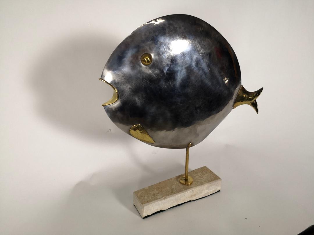 This elegant sculpture depicts a large whale in the modernist style of the European Art Deco oeuvre. The very high quality handmade metalwork of patinated, different metals, chrome steel and brass was made by the Hungarian Laszlo Pal Horvath
