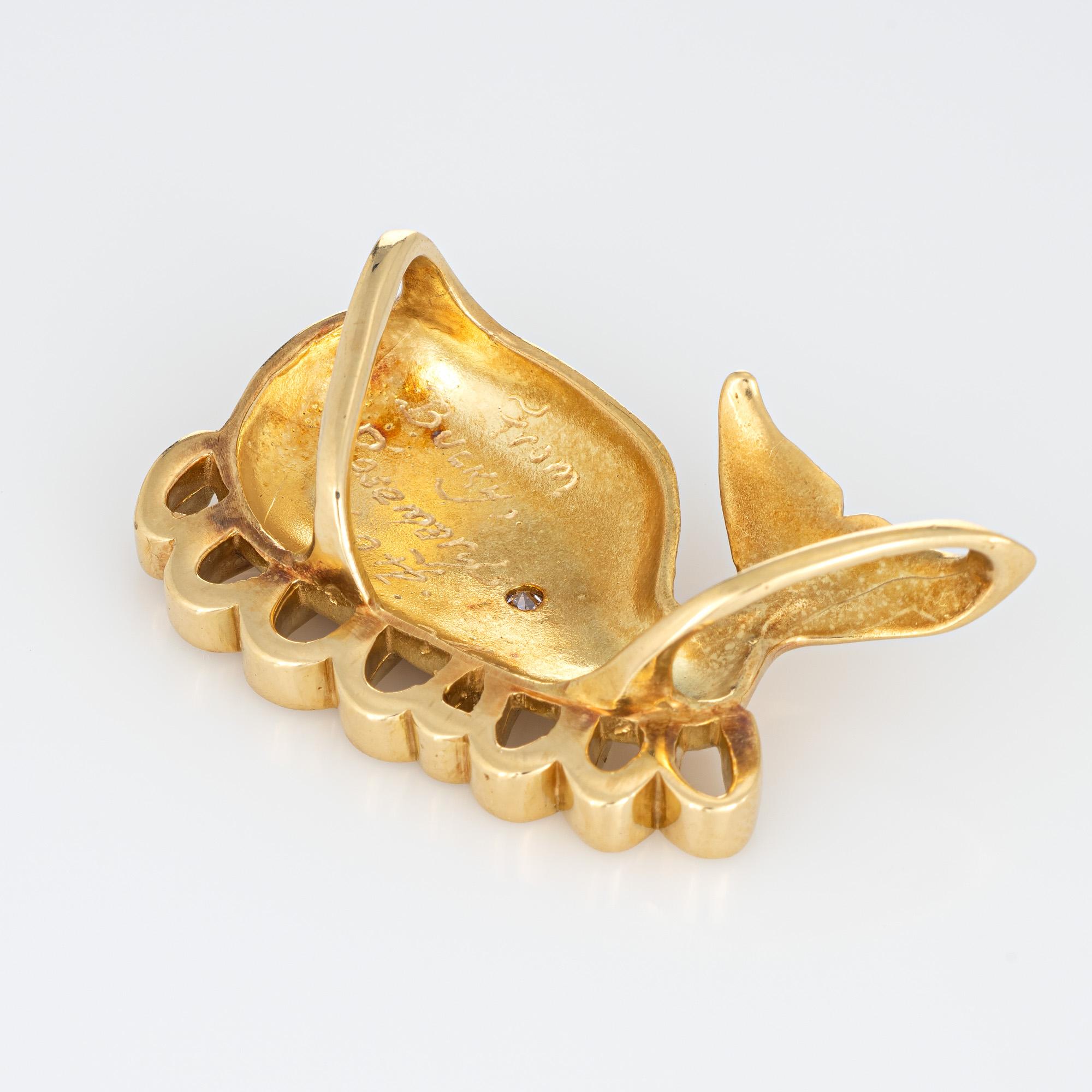 Finely detailed vintage whale pendant (enhancer) crafted in 18k yellow gold.  

One estimated 0.05 carat diamond is estimated at H-I color and VS2 clarity.

The unique pendant features a whale with wave detail to the base. The pendant features a