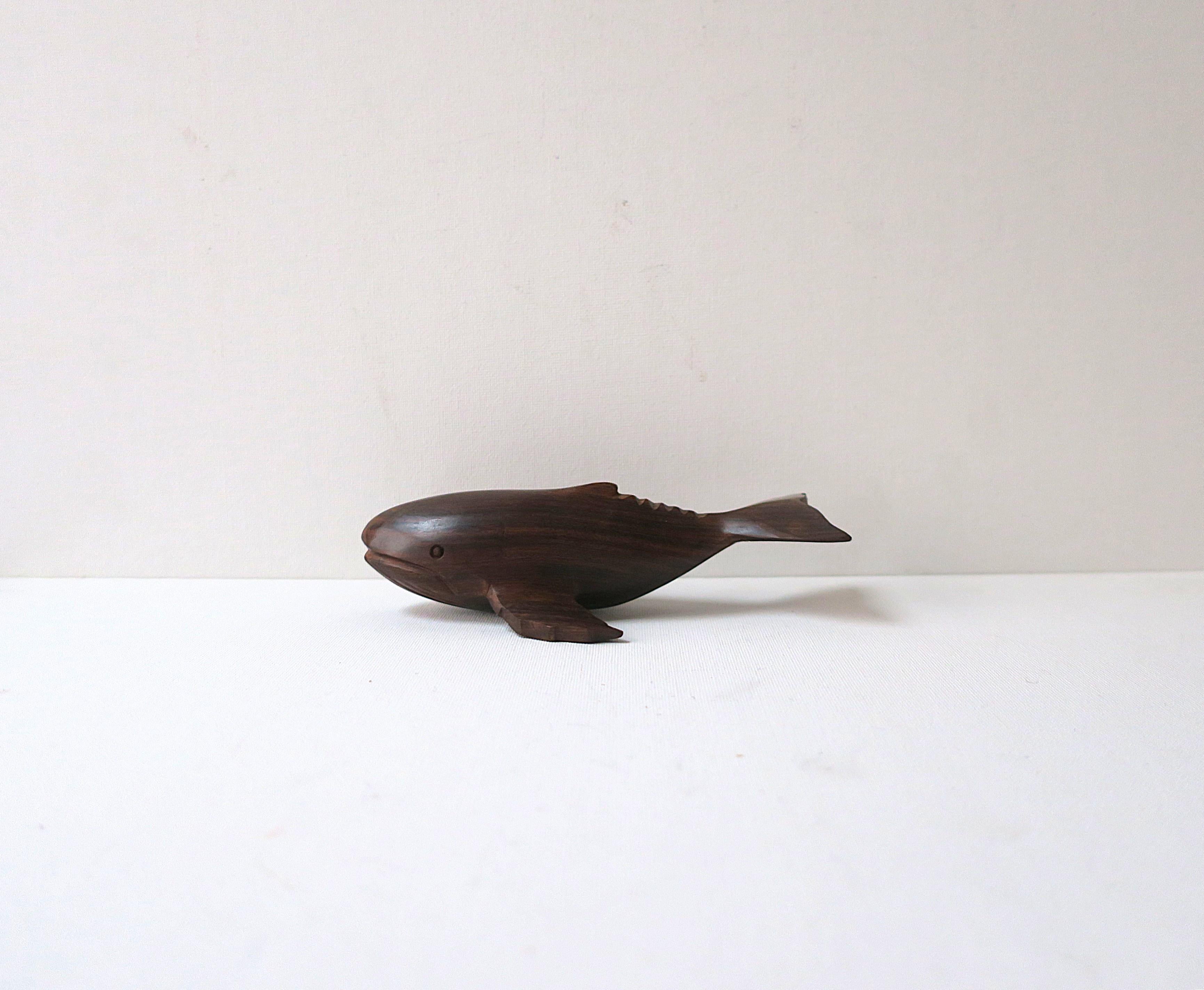 A hand carved, polished, whale sculpture decorative object in a rich rosewood, circa late-20th century to early 21st century. Excellent condition as shown in images and video. Dimensions: 3.25