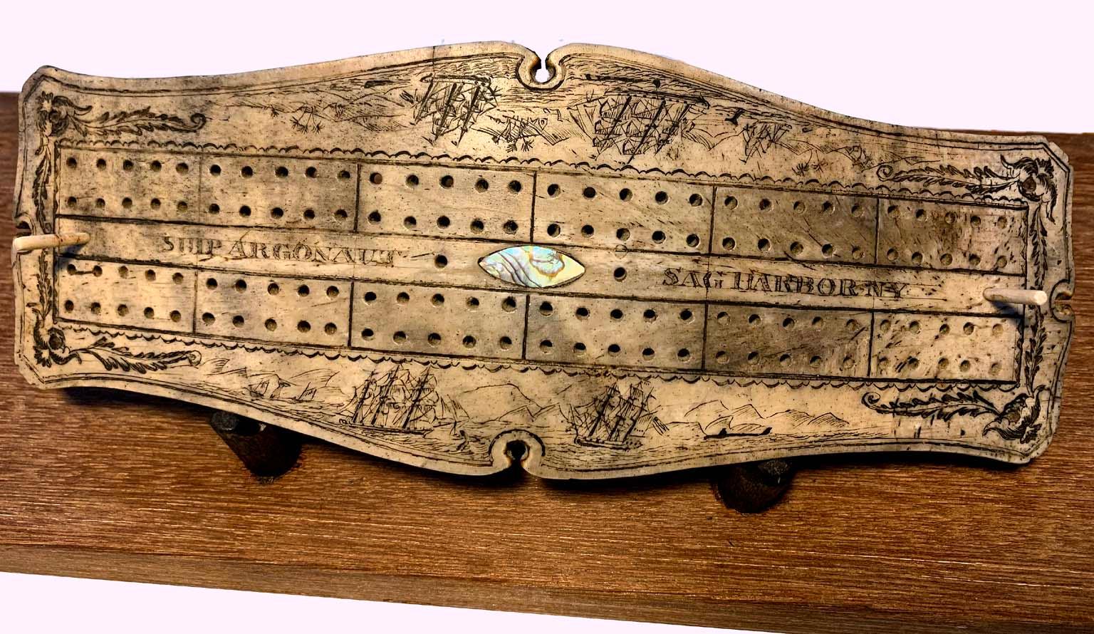 Authentic Scrimshaw carved into and antique tortoise shell with brass legs. Carved aboard the Ship Argonaut. A whaling ship from Sag Harbor New York from 1814-1832. The detailed carving is amazing with multiple ships, whales and alternating back