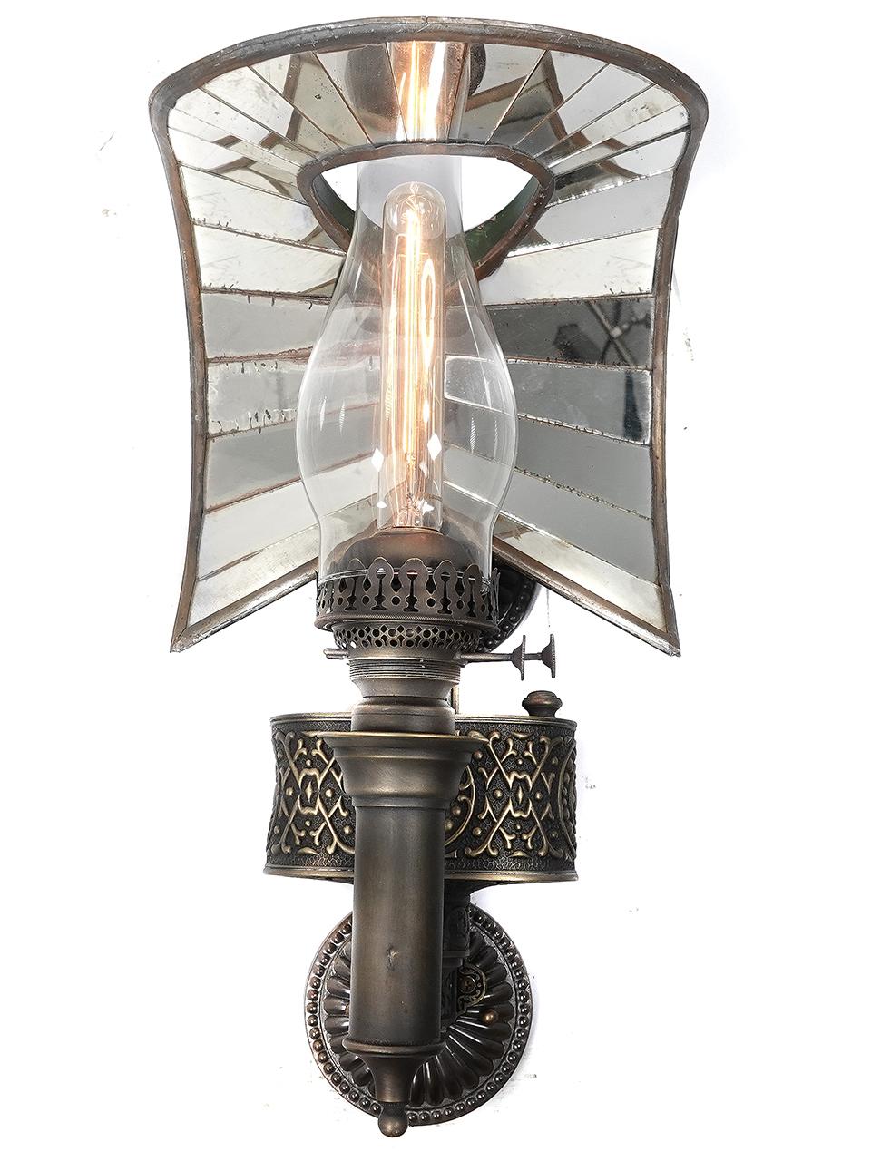 Wheeler mirrored reflectors are highly sought after and the whale tail examples are there most complex and rare. This rare reflector fitted to a decorative bronze Victorian railroad sconce makes a impressive and striking fixture. You don't see these