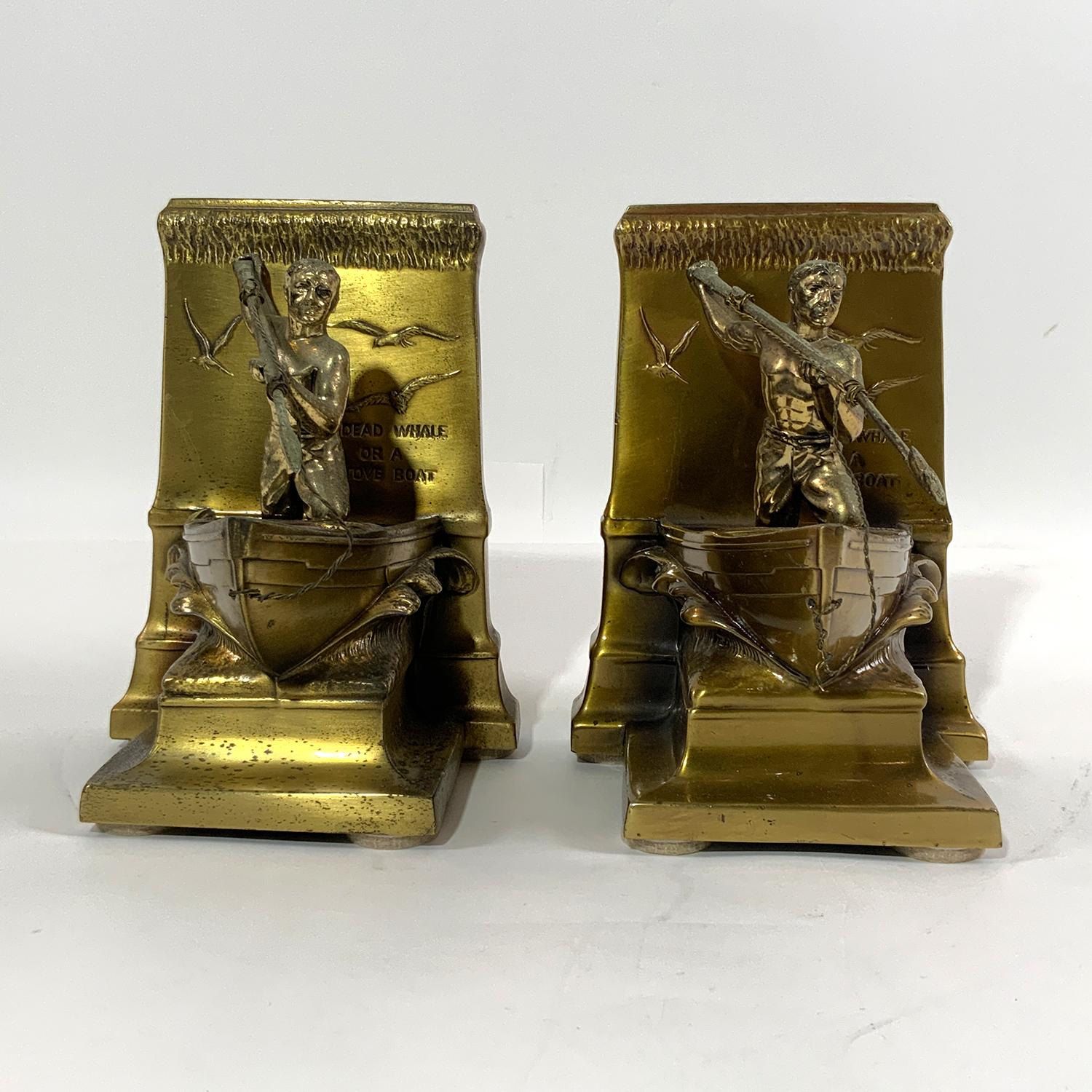 Pair of solid brass whaleboat bookends. Two bow of whaleboats with whalemen at the bow casting harpoons with splashing waves. Backs of bookends have a message. 