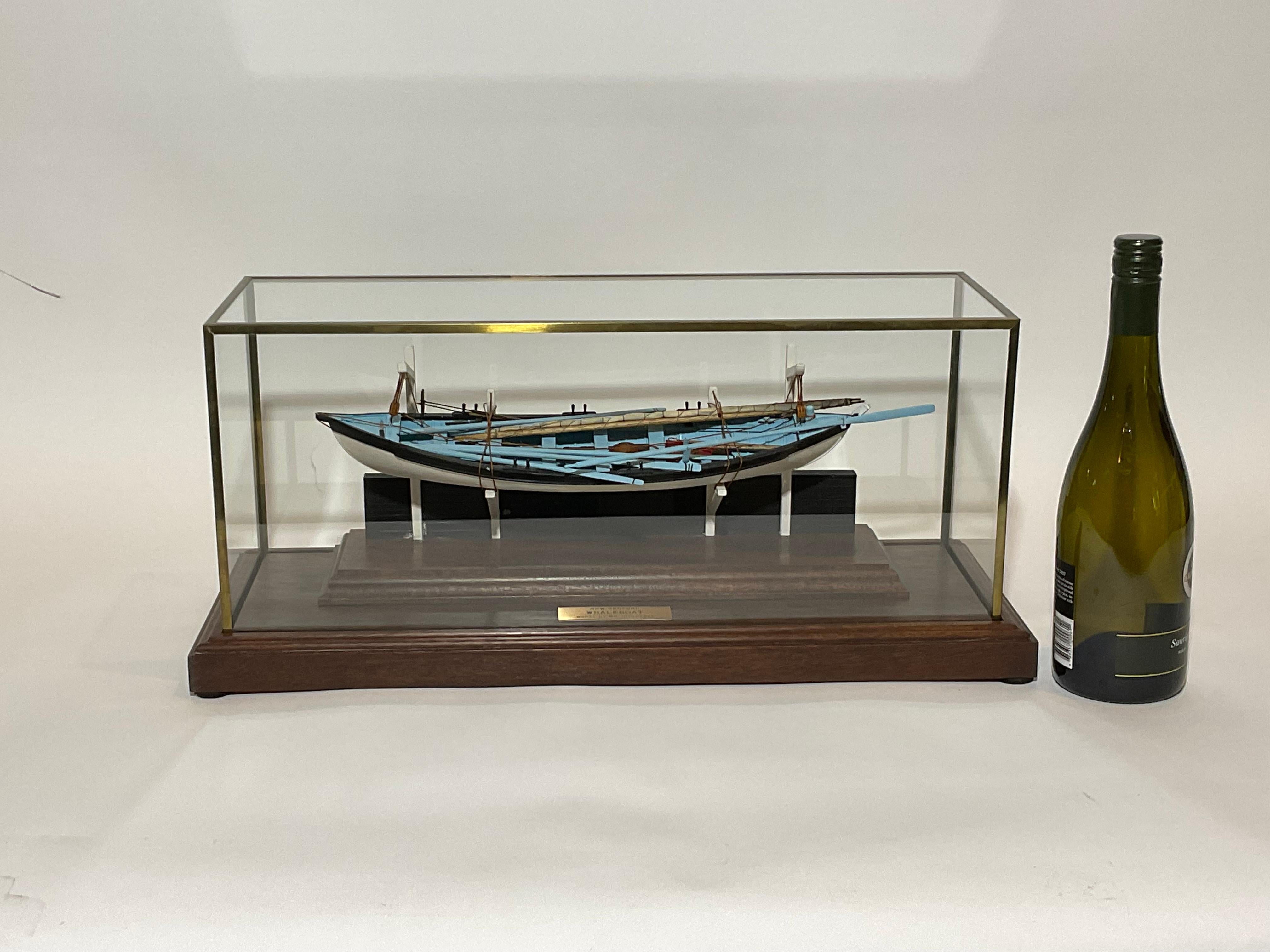 Cased model of a New Bedford Whaleboat mounted to a section of ships bulwark with davits. The model is outfitted with oars, sweep, mast, sail, lances, harpoons, line tubs, knife, axe, flag, etc.. Mounted into a custom glass case.

Weight:
Overall