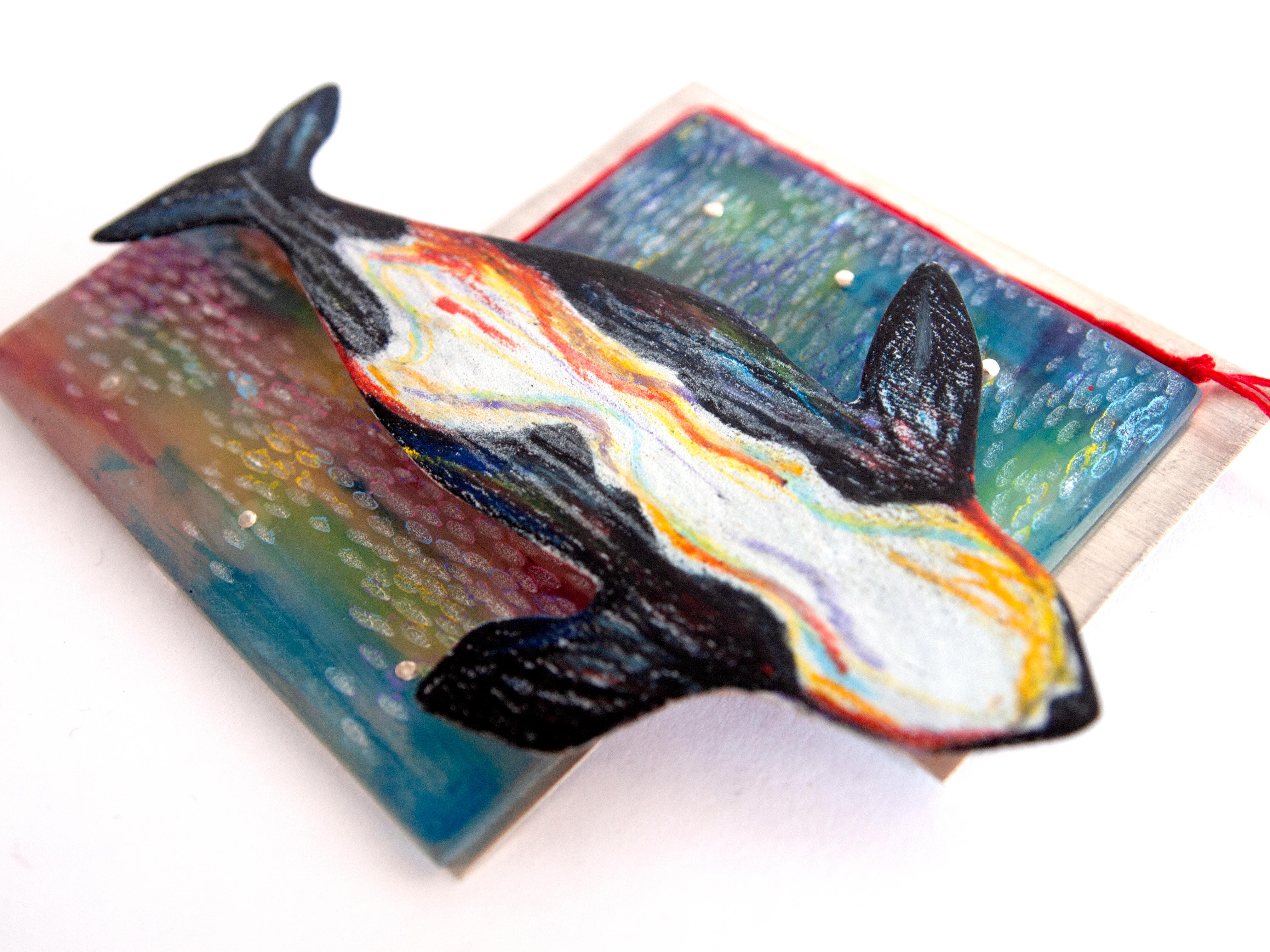'Whales in the Theater' brooch, based on a narrative poem and sketch study painting created by the artist, this one-of-a-kind brooch is loaded with symbolism and meaning.  

Layers of Sterling Silver, hand textured/painted resin, as well as color