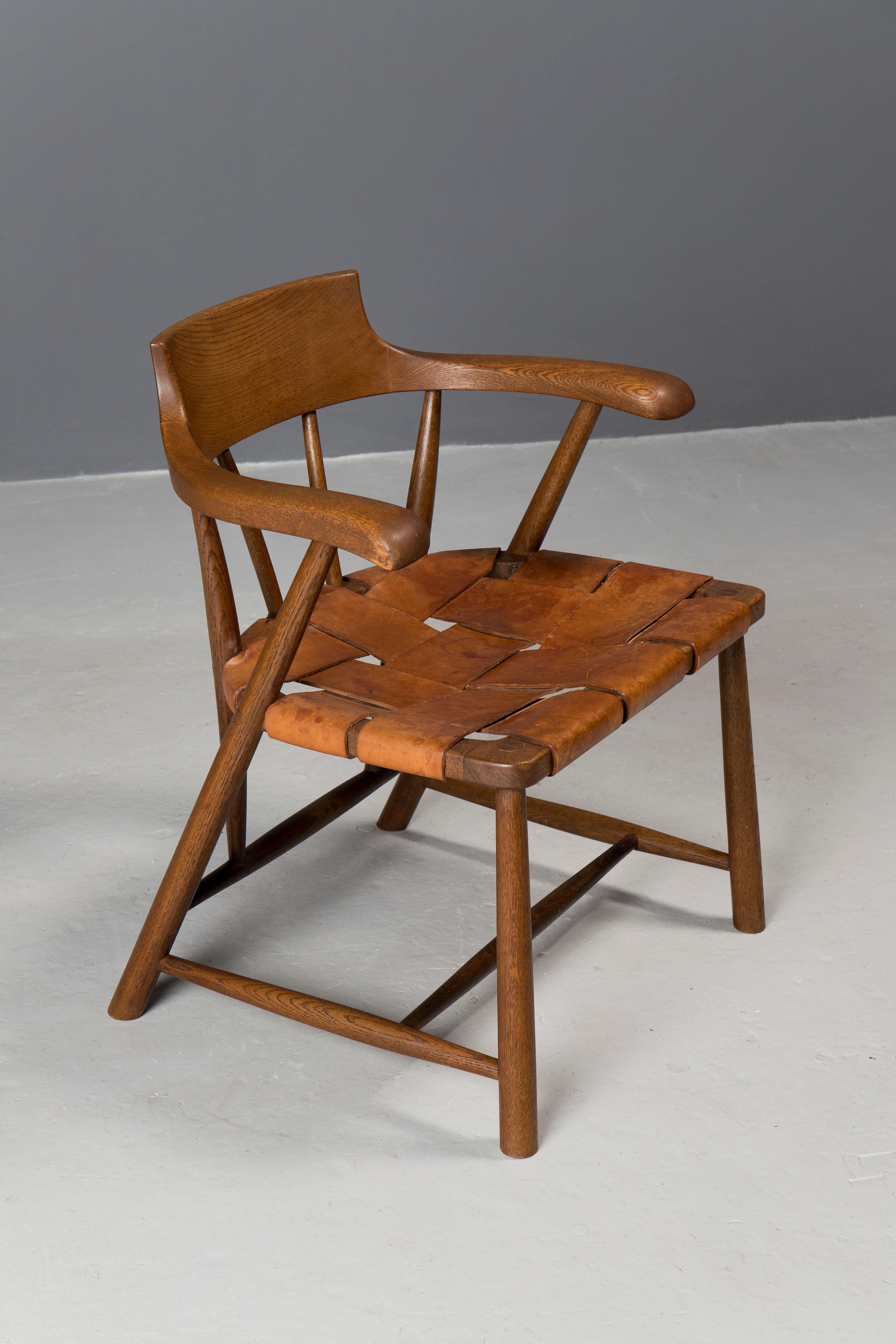 Important custom commission Captain's chair, created by studio artist Wharton Esherick in the 1960s.
Frame is hand carved in oak and seat is in beautiful woven cognac color saddler leather.
Exquisite form, scale and comfort.
Frame has been