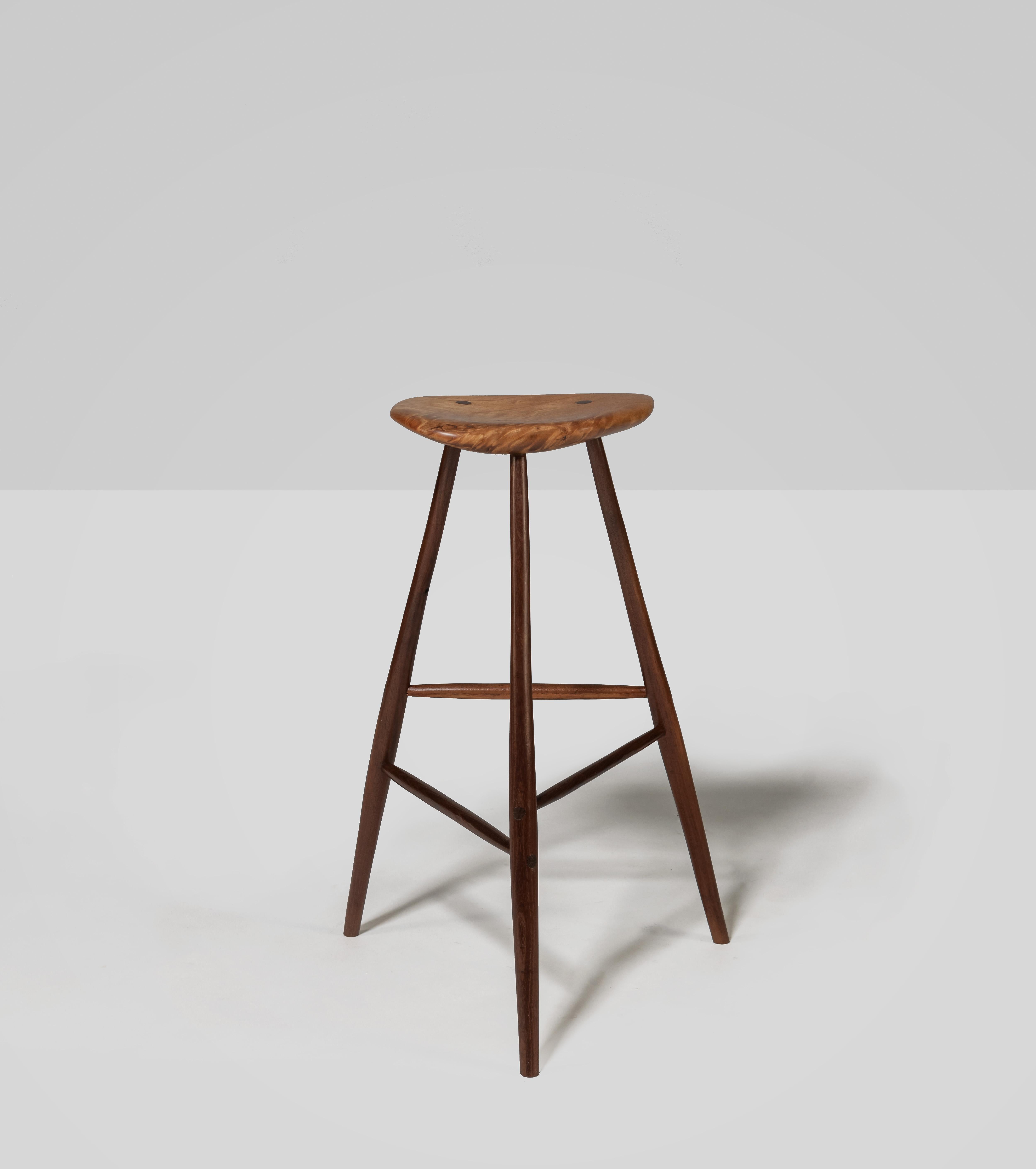 Iconic and beautiful Esherick stool,with nicely shaped through-tenon maple seat which sits upon 3  hand- carved walnut legs. In excellent condition, stool also signed and dated 