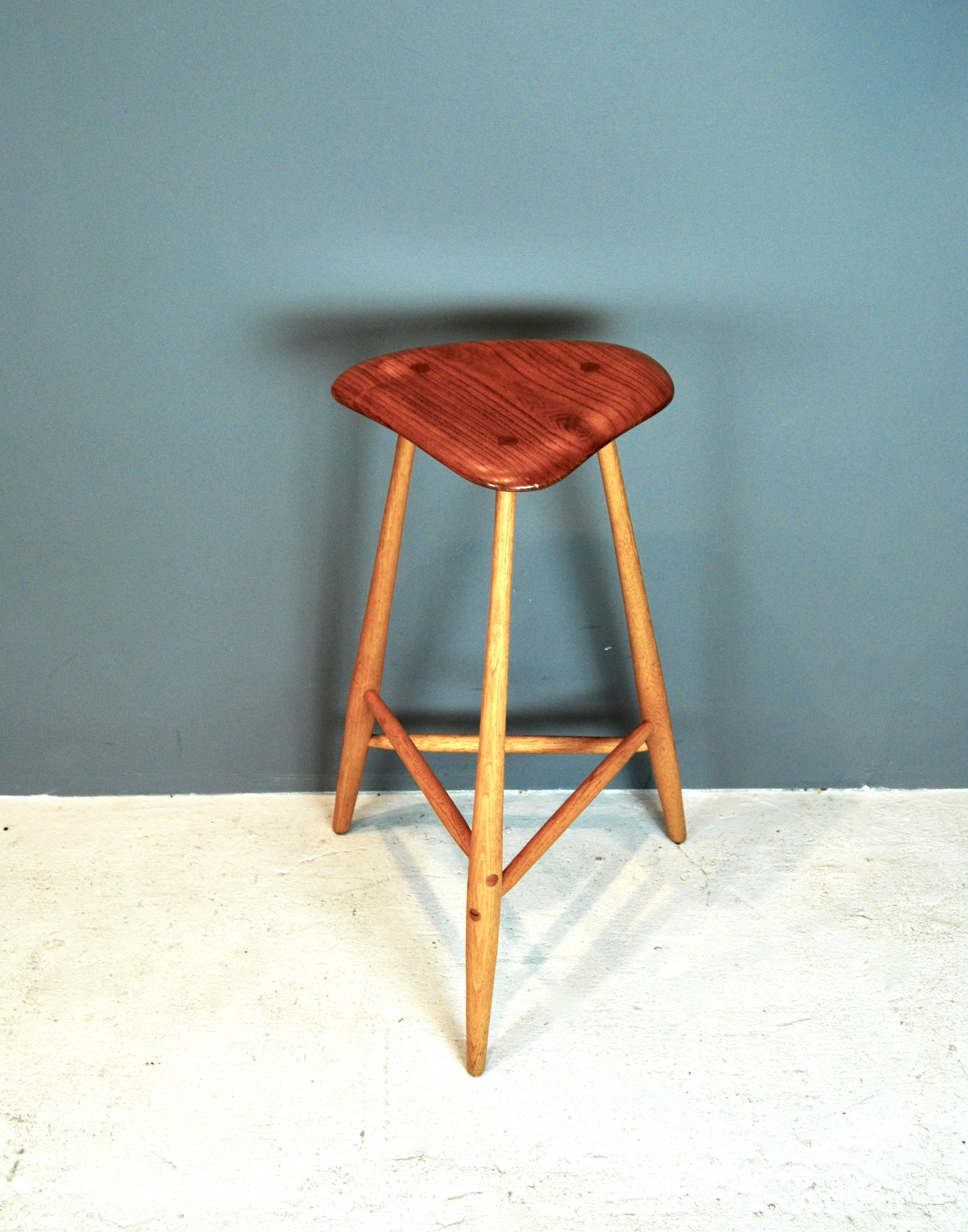 Rare, hand sculpted tall stool by one of the most important American studio woodworkers Wharton Esherick. This example is made of hickory and oak species with a beautiful freeform shaped seat and long tapered legs.
There are no breaks or repairs to