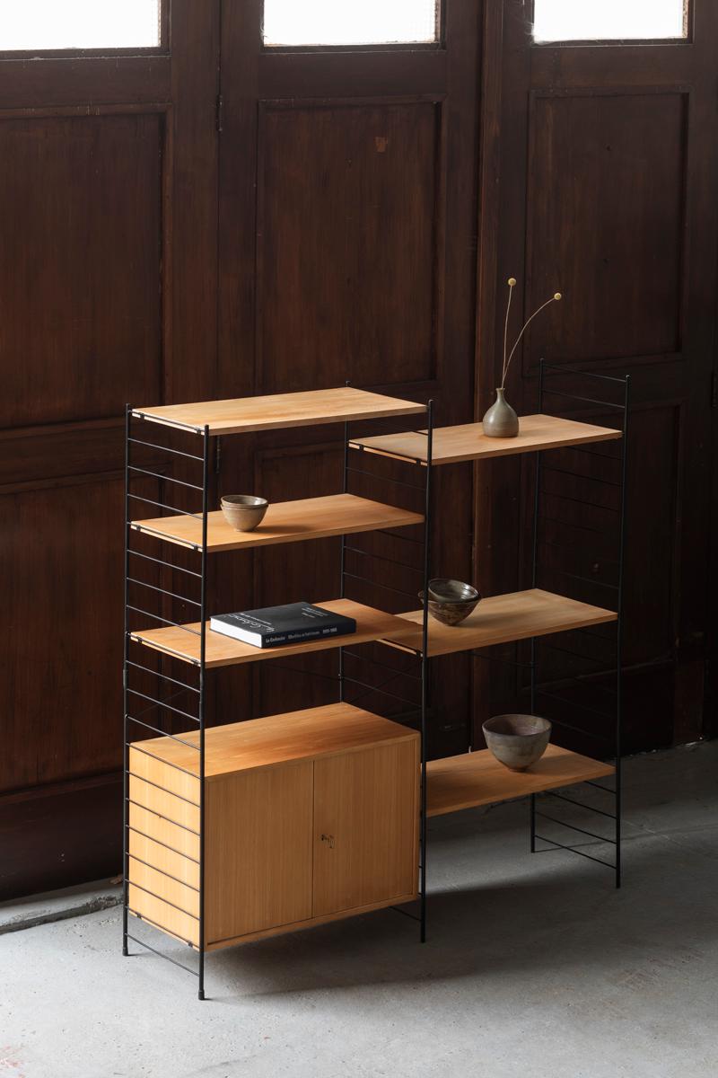 2-Bay, freestanding shelving system by WHB, designed and produced in Germany in the 1960s. Black lacquered metal ladders with birch veneered elements, easy to install and adjust. The system features one cabinet and 6 shelves. They rest easily on the