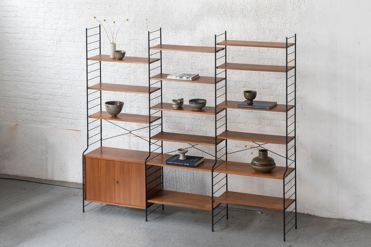 3-piece wall unit produced by WHB in Germany around 1960. This freestanding setup features black lacquered metal ladders, a cabinet and a variety of shelves. Can be arranged as desired. In good condition with some using marks as shown in the