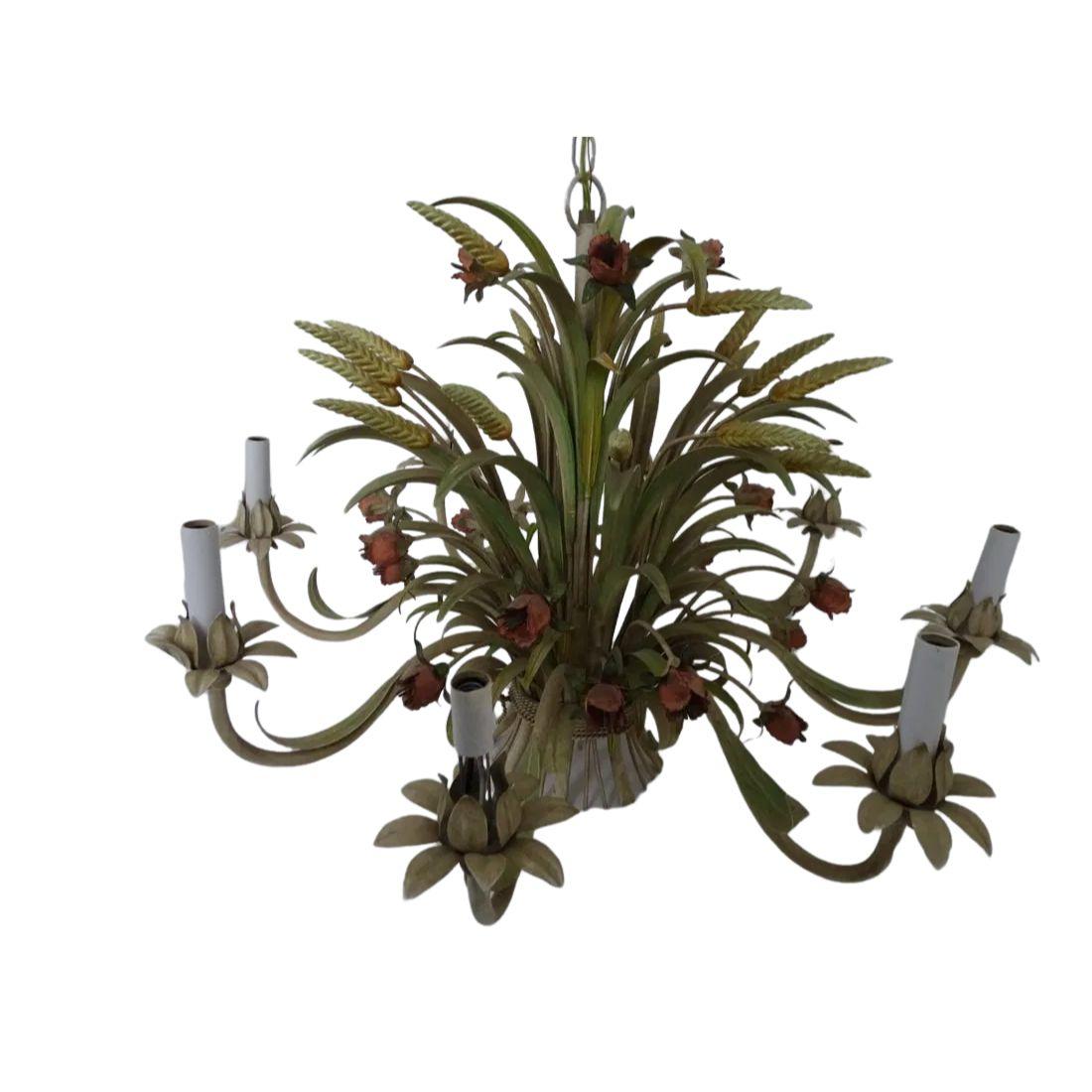 This eight light chandelier is a stunning blend of elegance and rustic charm, crafted from painted tole in the form of a graceful wheat sheaf, adorned with delicate flowers. The chandelier features eight candle form lights, each encased in a