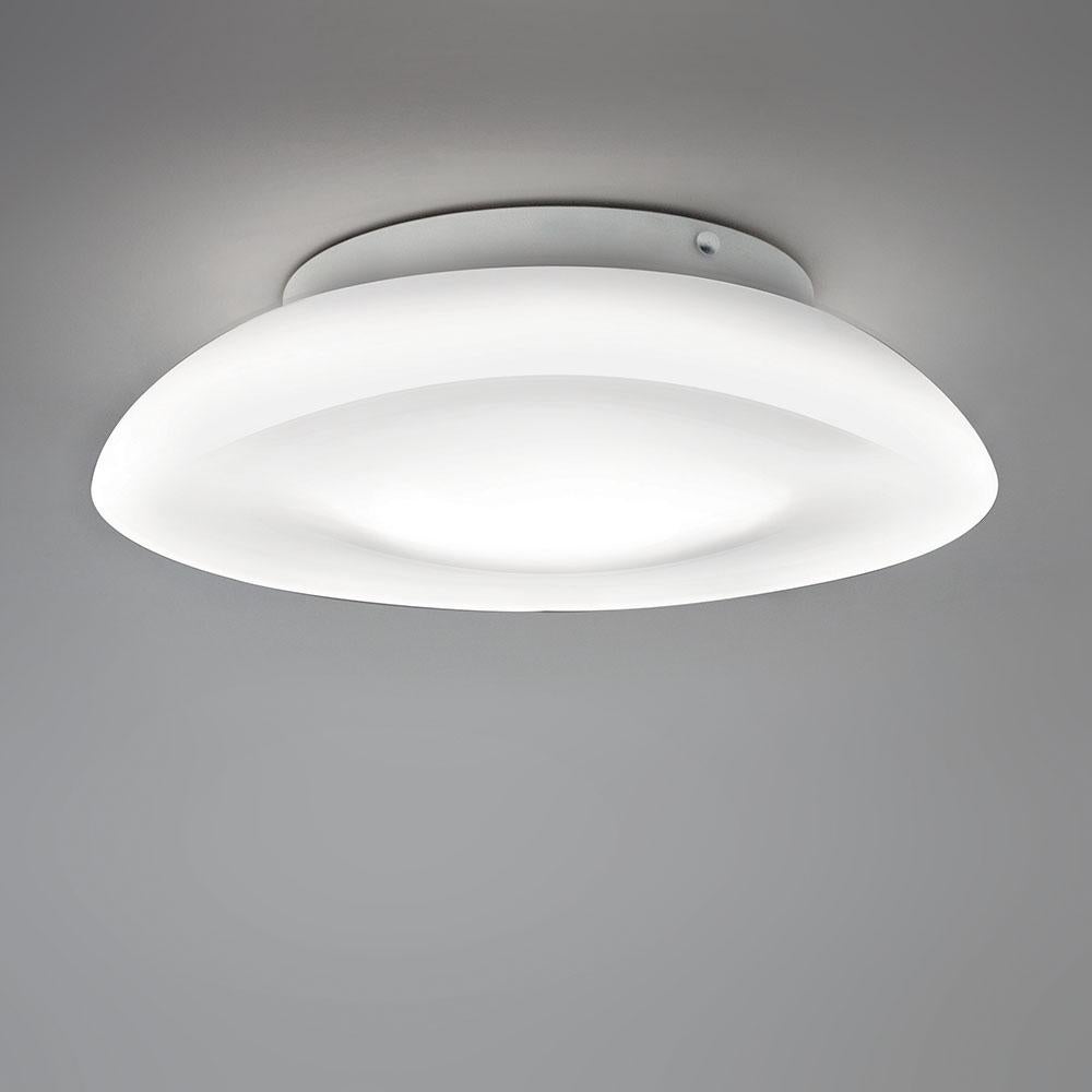 Ceiling or wall-mounted circular diffuser in white opaline handblown glass. Mounting plate white powder-coated steel with steel fasteners which mounts to standard junction boxes centered on Luminaire. 
Diffused lighting. 2 sizes: 15 is