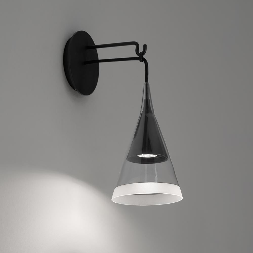 Vigo reinterprets the concept of an old-fashioned street light for domestic environment. Consisting of dual overlapping cones with one placed inside and flush with its mate.

The inner cone is made of black metal while the outer is transparent,