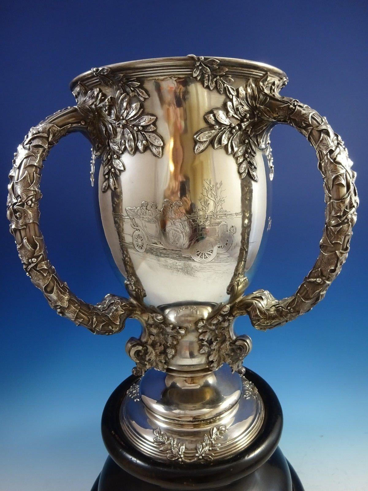 Magnificent 1907-1909 MacDonald & Campbell Perpetual Endurance Auto Trophy of the Quaker City Motor Club

This superb monumental sterling silver trophy retailed by J.E. Caldwell in Philadelphia features three handles with applied ivy and berries.