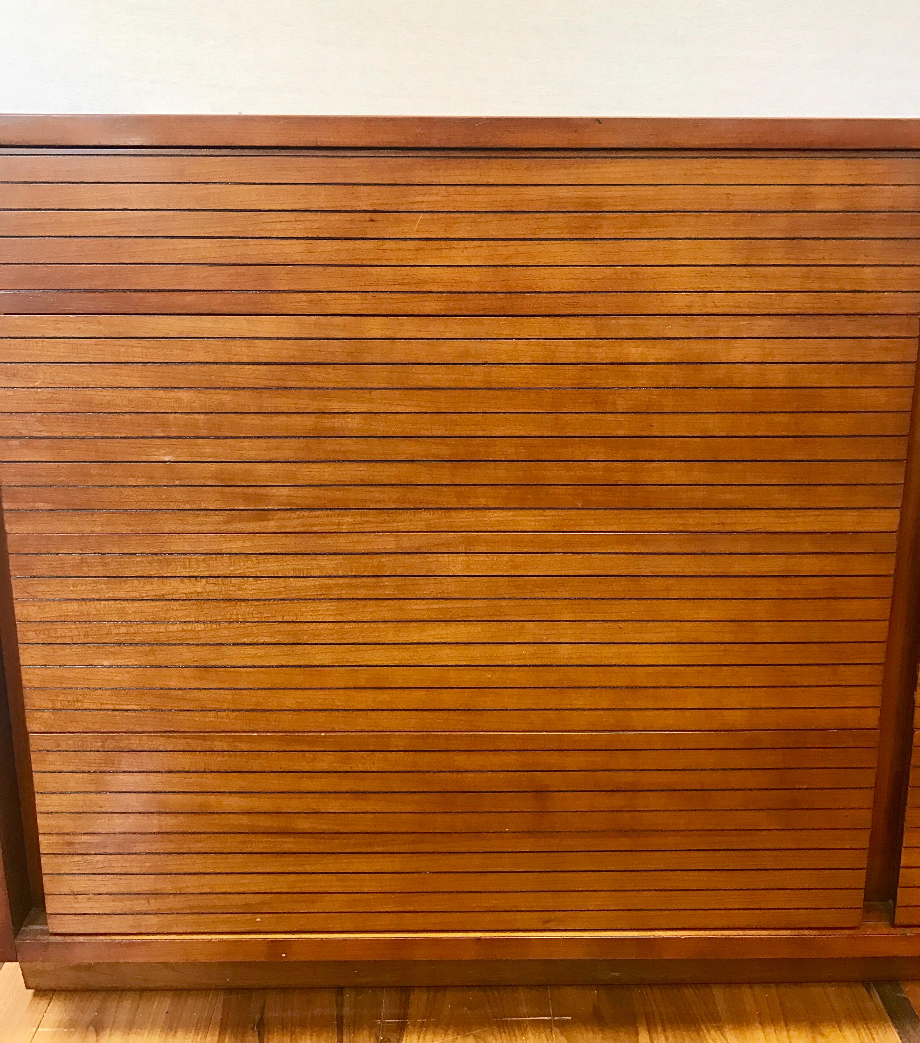 Rare signed Henredon Heritage midcentury dresser, chest of drawers done in walnut. Note the piece is on wheels also for ease of movement.