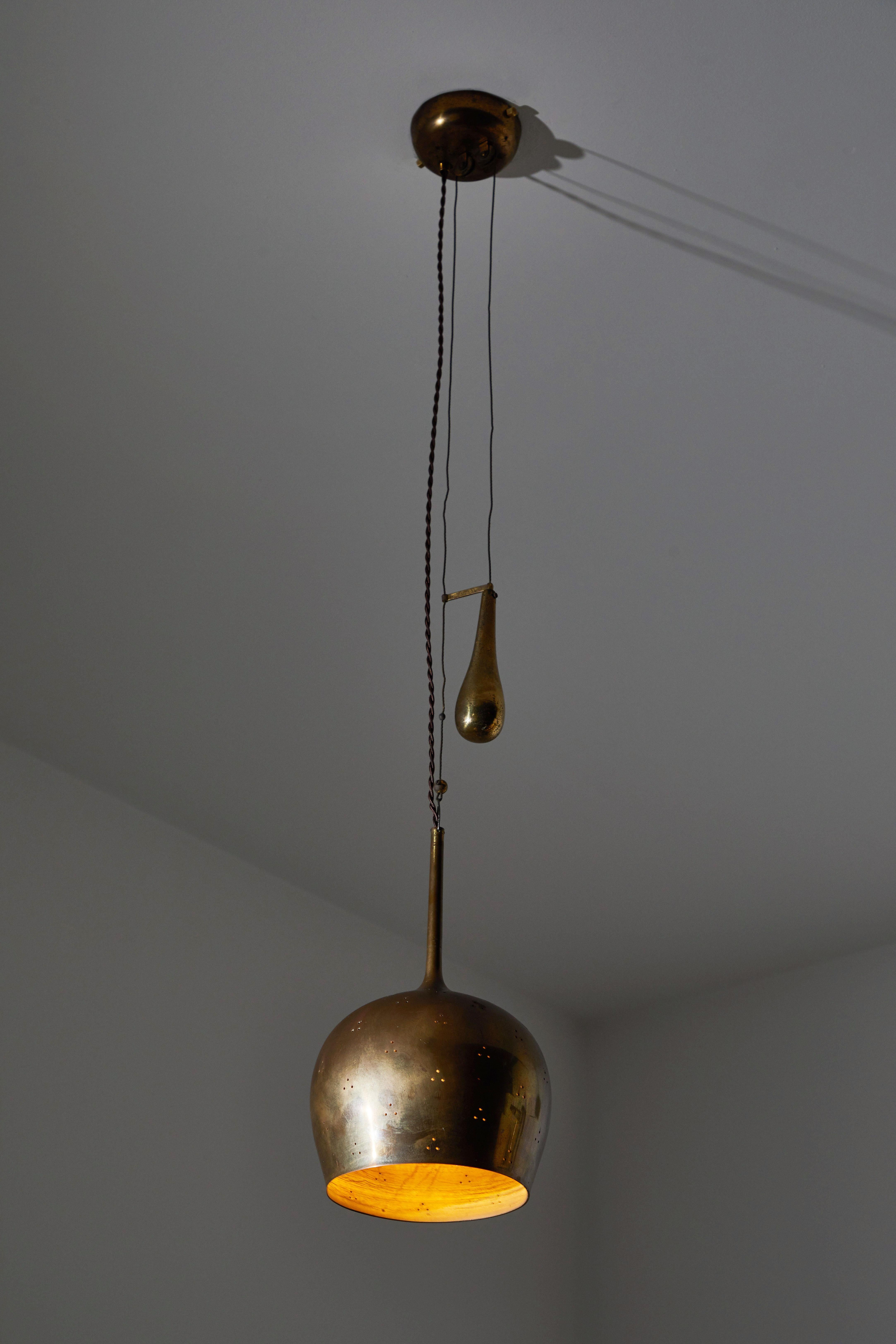 Counterweight pendant by Paavo Tynell. Designed and manufactured in Finland, circa 1950s. Perforated brass 
wire and cloth cord. Wired for US junction boxes. Takes one E27 75w maximum bulb.
Fully Extended Height: 64